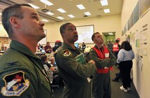 HOUMA, La. – (left to right) Col. Jeff Fiebig, the mobilization assistant to the commander, First Air Force, Tyndall AFB, Fla., Maj. Gen. Garry Dean, the joint force air component commander for North American Aerospace Defense Command and U.S. Northern Command, and Cmdr. Drew Cromwell, air operations branch chief for the Houma Incident Command Post, analyze safety information in the operations center in the central operations room, June 15, 2010. Dean visited the command post to discuss ways the Air Force can assist in the Gulf for the nation’s largest oil spill response and recovery.  U.S. Coast Guard photo by Petty Officer 3rd Class Robert Brazzell.