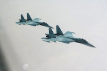 OVER THE PACIFIC OCEAN - Two Russian SU-27 fighters take up position alongside a simulated highjacked aircraft during Exercise VIGILANT EAGLE Aug. 8. VIGILANT EAGLE is a cooperative exercise involving the North American Aerospace Defense Command and the Russian Air Force. The exercise scenario creates a situation that requires both the Russian Air Force and NORAD to launch or divert fighter aircraft to investigate and follow a "hijacked" airliner. The exercise focuses on shadowing and the cooperative hand-off of the monitored aircraft between fighters of the participating nations. 

(U.S. Army photo by Maj. Mike Humphreys) 

