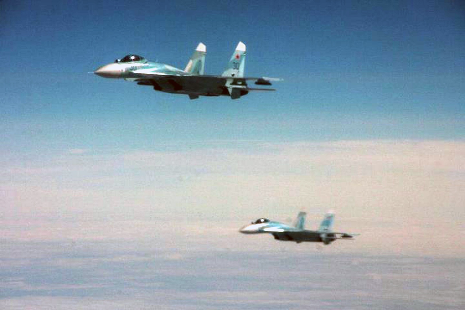 OVER THE PACIFIC OCEAN - Two Russian SU-27 fighters intercept Fencing 1220, the target of interest for Exercise VIGILANT EAGLE Aug. 8. VIGILANT EAGLE is a cooperative exercise involving the North American Aerospace Defense Command and the Russian Air Force. The exercise scenario creates a situation that requires both the Russian Air Force and NORAD to launch or divert fighter aircraft to investigate and follow a "hijacked" airliner. The exercise focuses on shadowing and the cooperative hand-off of the monitored aircraft between fighters of the participating nations. 

(U.S. Army photo by Maj. Mike Humphreys) 

