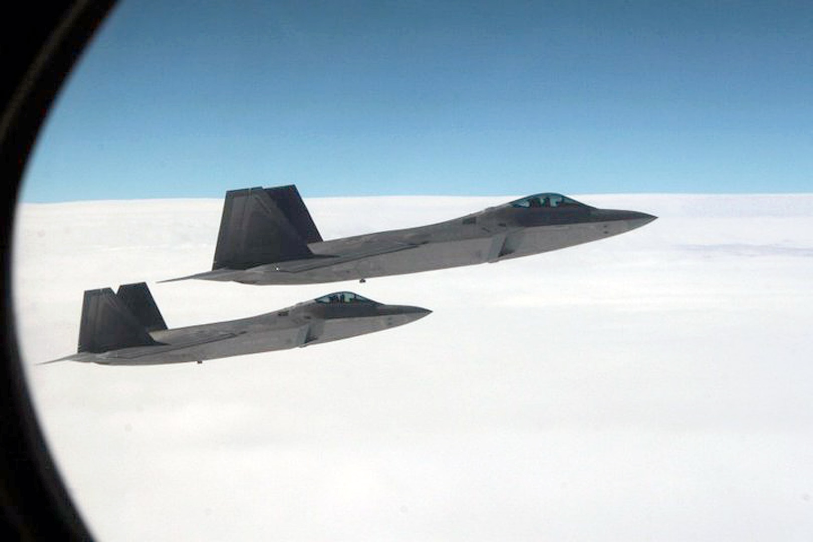 OVER THE PACIFIC OCEAN - A pair of F-22 Raptor fighters intercept Fencing 1220, the target of interest for Exercise VIGILANT EAGLE, shortly after take-off, Aug. 8. VIGILANT EAGLE is a cooperative exercise involving the North American Aerospace Defense Command and the Russian Air Force. The exercise scenario creates a situation that requires both the Russian Air Force and NORAD to launch or divert fighter aircraft to investigate and follow a "hijacked" airliner. The exercise focuses on shadowing and the cooperative hand-off of the monitored aircraft between fighters of the participating nations. 

(U.S. Army photo by Maj. Mike Humphreys) 

