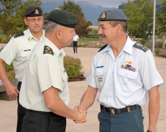 PETERSON AIR FORCE BASE, Colo. - Canadian Lt. Gen. J. M. Duval greets Canadian Lt. Gen. Walter Semianiw, Canada Command commander, outside the North American Aerospace Defense Command and U.S. Northern Command headquarters Aug. 9. Semianiw visited USNORTHCOM to meet with Navy Adm. James Winnefeld, USNORTHCOM commander, and receive an overview of the command's mission and capabilities. It was his first visit to the command since assuming command of Canada Command on July 7. 

(U.S. Air Force photo by Staff Sgt. Thomas J. Doscher) 

