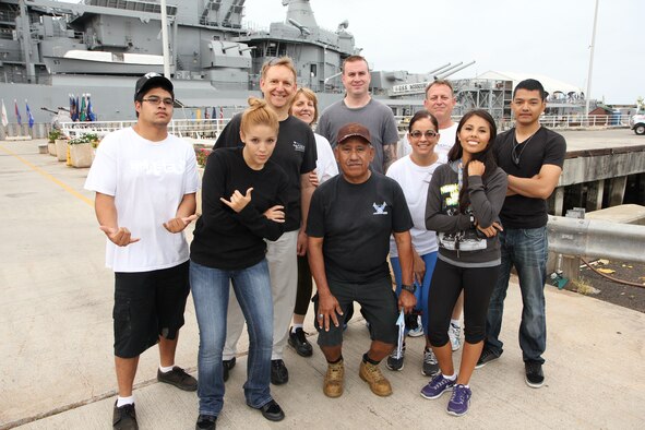 Master Sgt. Larry A. Castillo, center, a cargo manager with the 48th Aerial Port Squadron, 624th Regional Support Group, Joint Base Pearl Harbor-Hickam, Hawaii, poses for a photo with reservists and family members from the 624th RSG in front of the Battleship Missouri Memorial, Pearl Harbor, Hawaii, Saturday, April 13, 2013. Castillo, who learned wood-working, welding and metal fabrication from the Navy’s Seabees school, organized the volunteer group to help restore teak wood from the original decks of the USS Missouri to be sold in the memorial’s gift shop. (US Air Force photo by Tech. Sgt. Phyllis E. Keith)