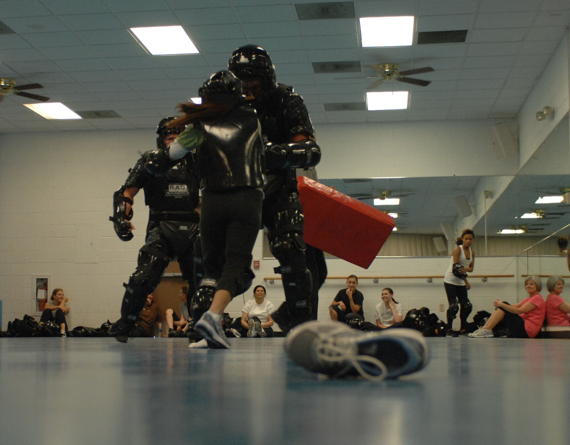 Staff Sgt. Ryan Hauck, 355th Security Forces Squadron certified R.A.D. instructor, blocks a student from escaping during an attack scenario at Davis-Monthan Air Force Base, Ariz., April 25th, 2013. The class is free to any woman, age nine and above, who has base access. (U.S. Air Force photo by Airman 1st Class Betty R. Chevalier/released)