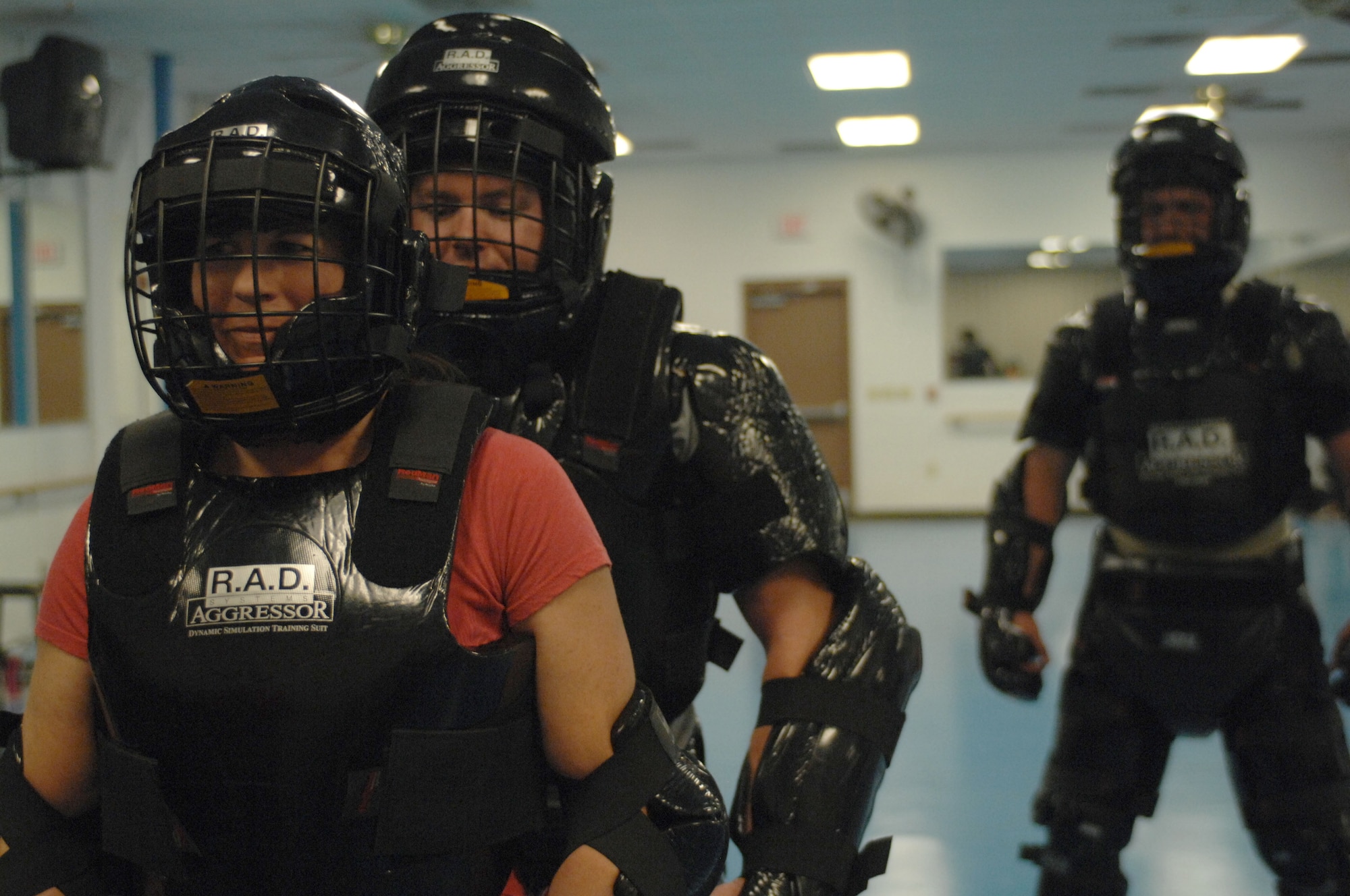 U.S. Air Force Airman Joel Burdett, 355th Security Forces Squadron certified R.A.D. instructor, prepares to run an attack scenario with a student in a Rape Aggression Defense Systems class at Davis-Monthan Air Force Base, Ariz., April 25th, 2013. Burdett and 6 other SFS members volunteer to teach R.A.D. classes about once a month here. (U.S. Air Force photo by Airman 1st Class Betty R. Chevalier/released)