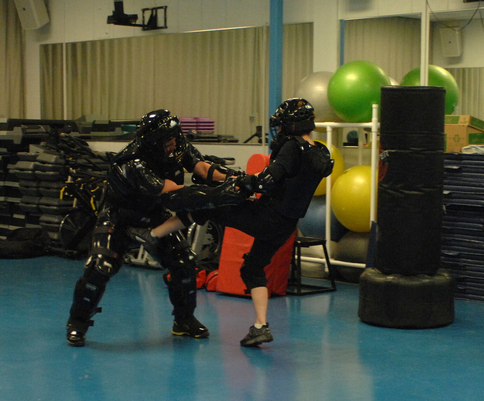 U.S. Air Force Airman Joel Burdett, 355th Security Forces Squadron certified R.A.D. instructor, plays an attacker with a student in a Rape Aggression Defense Systems class at Davis-Monthan Air Force Base, Ariz., April 25th, 2013. R.A.D. is class that teaches women basic self-defense tactics and techniques. (U.S. Air Force photo by Airman 1st Class Betty R. Chevalier/released)