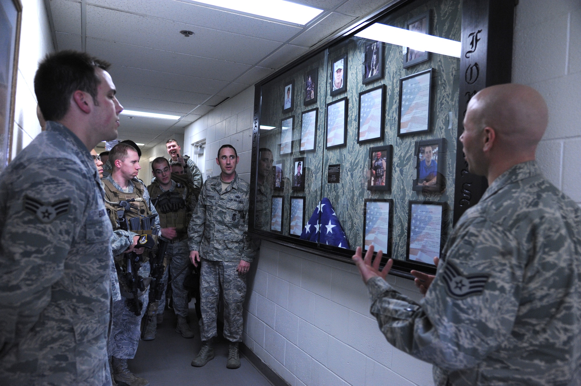 (Far right) Staff Sgt. Timothy Lombardi, 341st Security Forces Group equipment NCO in charge, Tech. Sgt. David Ellingson, 341st SFG vehicle NCO in charge, center, and Kenneth Swan, 341st SFG resource advisor (not pictured), presented a fallen defenders shadowbox to Malmstrom’s Tactical Response Force members at the Vehicle Readiness Center on April 19. Nearly two years in the making, the three created the memorial box to honor security forces Airmen who have made the ultimate sacrifice fighting the War on Terror. (U.S. Air Force photo/Airman 1st Class Katrina Heikkinen)
 

