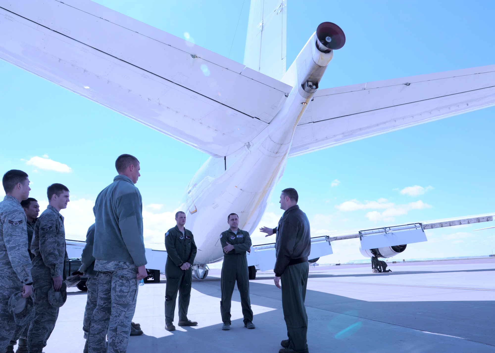 (Far right) Capt. Brian Lane, 625th Strategic Operations Squadron, Airborne Launch Control System combat operations chief, out of Offutt Air Force Base, Neb., explains the durability of the E-6B ALCS aircraft (pictured in background) during a tour at Holman Aviation on April 22. Nearly 50 members of Team Malmstrom had the opportunity to tour the aircraft, which is used to provide survivable, reliable and endurable airborne command, control and communications between the National Command Authority and U.S strategic and non-strategic forces. (U.S. Air Force photo/Airman 1st Class Katrina Heikkinen)  