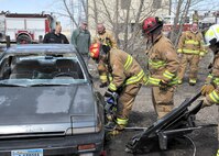 Lt. Gen. James Kowalski, commander of Air Force Global Strike Command, with help from members of Malmstrom’s fire department, uses the Jaws of Life to cut through the side of a vehicle during his tour of the 341st Civil Engineer Squadron Fire Trainer on April 22.  Kowalski visited Team Malmstrom members during a tour of the base April 21 - 24.  (U.S. Air Force photo/John Turner) 