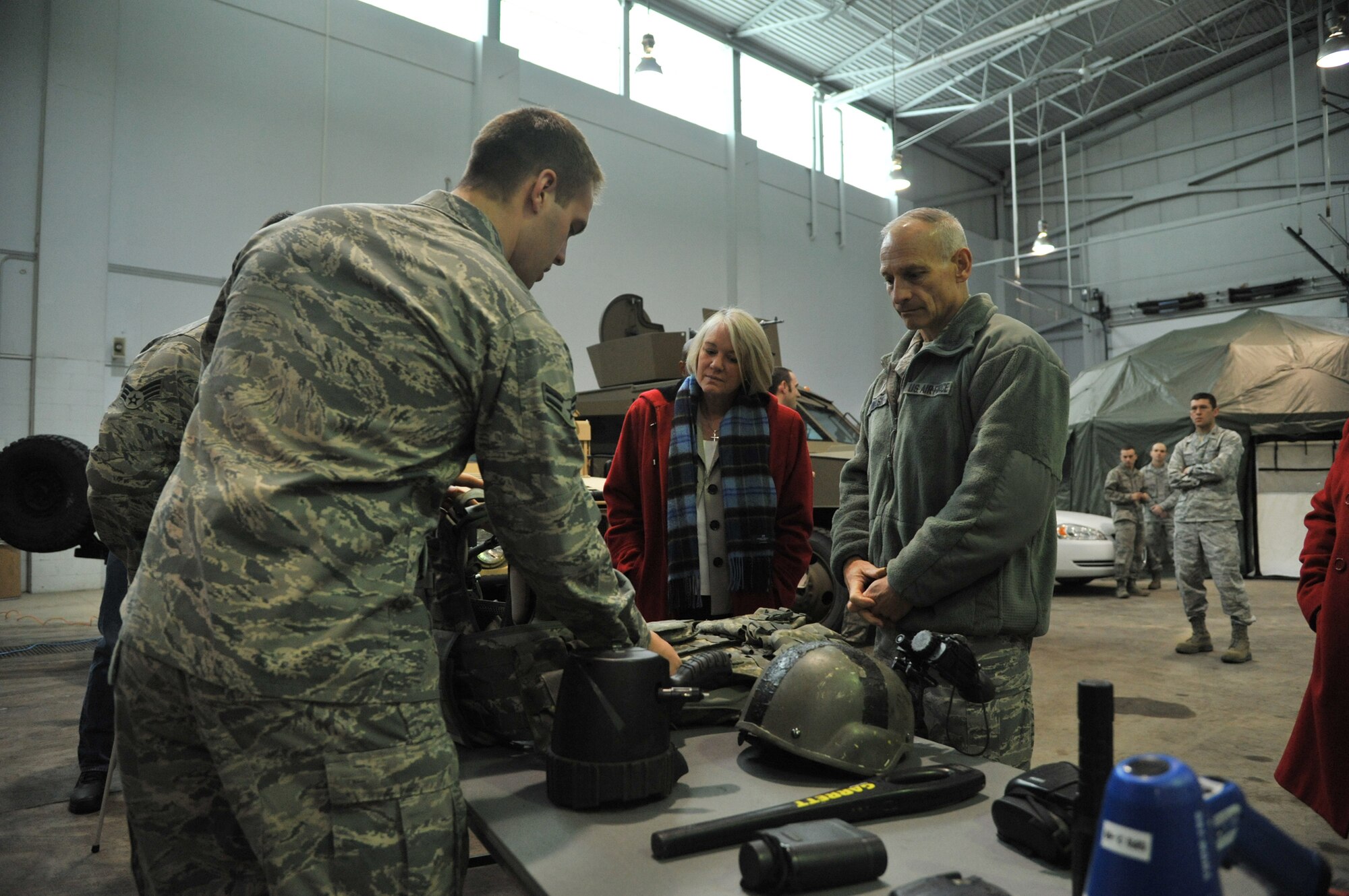 Lt. Gen. James Kowalski, commander of Air Force Global Strike Command, and his wife, Julie, listen to Airman 1st Class Alex Callahan, 741st Missile Security Forces Squadron security escort team member, explain the uses of various security forces equipment during an Emergency Responders Expo at the 341st Civil Engineer Squadron High Bay on April 22.  Julie also had the chance to meet with wing leadership spouses during her trip to Malmstrom.  (U.S. Air Force photo/John Turner)