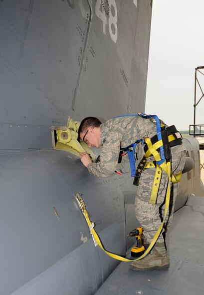 Airman 1st Class Zachary Dutton, 2nd Maintenance Squadron Fabrication flight, installs an air lock fastener to the vertical stabilizer of a B-52H Stratofortress during a phase inspection on Barksdale Air Force Base, La., April 26, 2013. The fastener connects a panel called an elephant air plate to the fuselage of the aircraft. (U.S. Air Force photo/Airman 1st Class Andrew Moua)