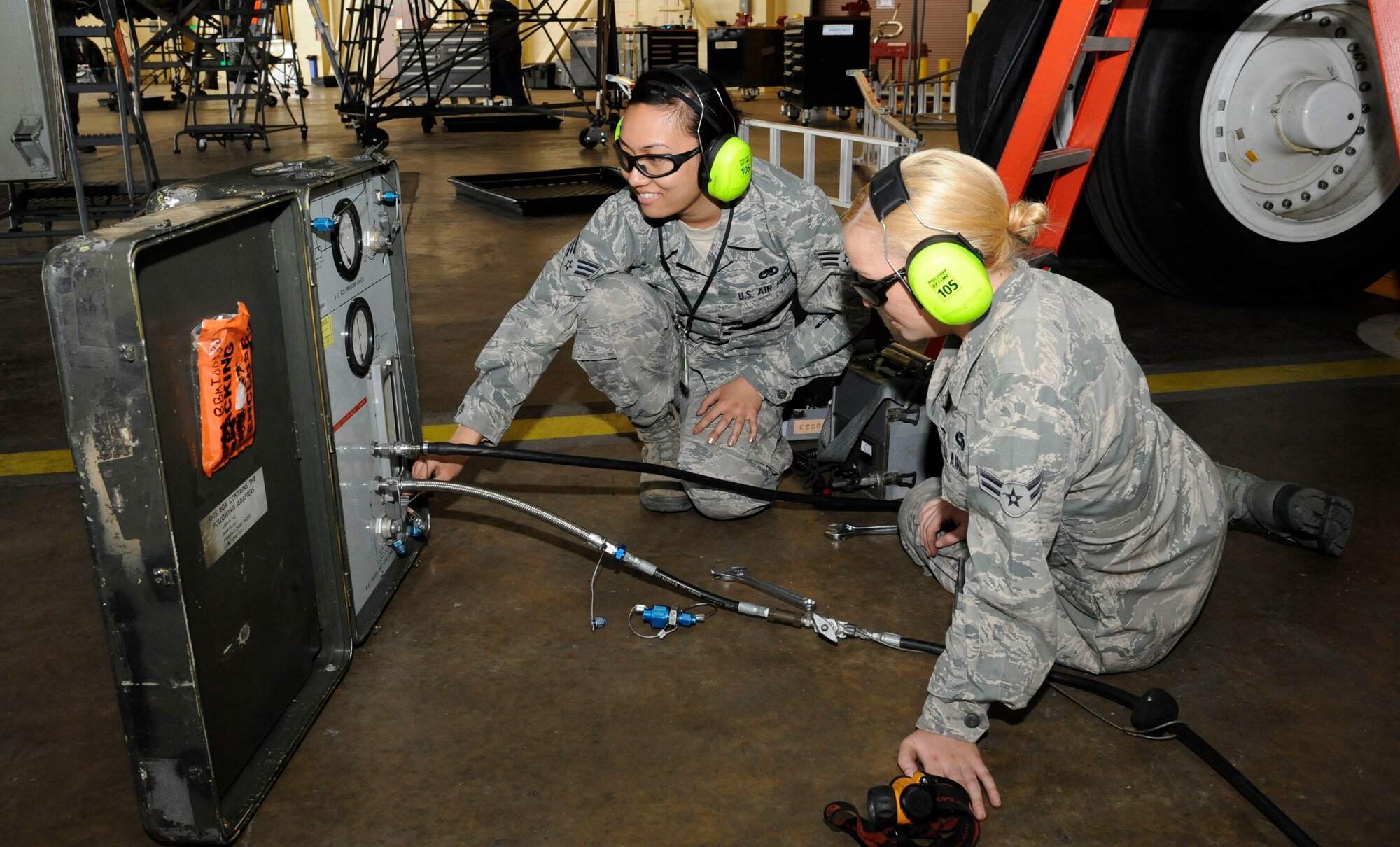 Senior Airman Kristin Saenz and Airman 1st Class Kristen McConnell, 2nd Maintenance Squadron Accessories flight electrical and environmental section, conduct a missile leak check on a B-52H Stratofortress on Barksdale Air Force Base, La., April 26, 2013. The check makes sure the weapon systems of the aircraft work properly and that any fittings are properly sealed. (U.S. Air Force photo/Airman 1st Class Andrew Moua) 
