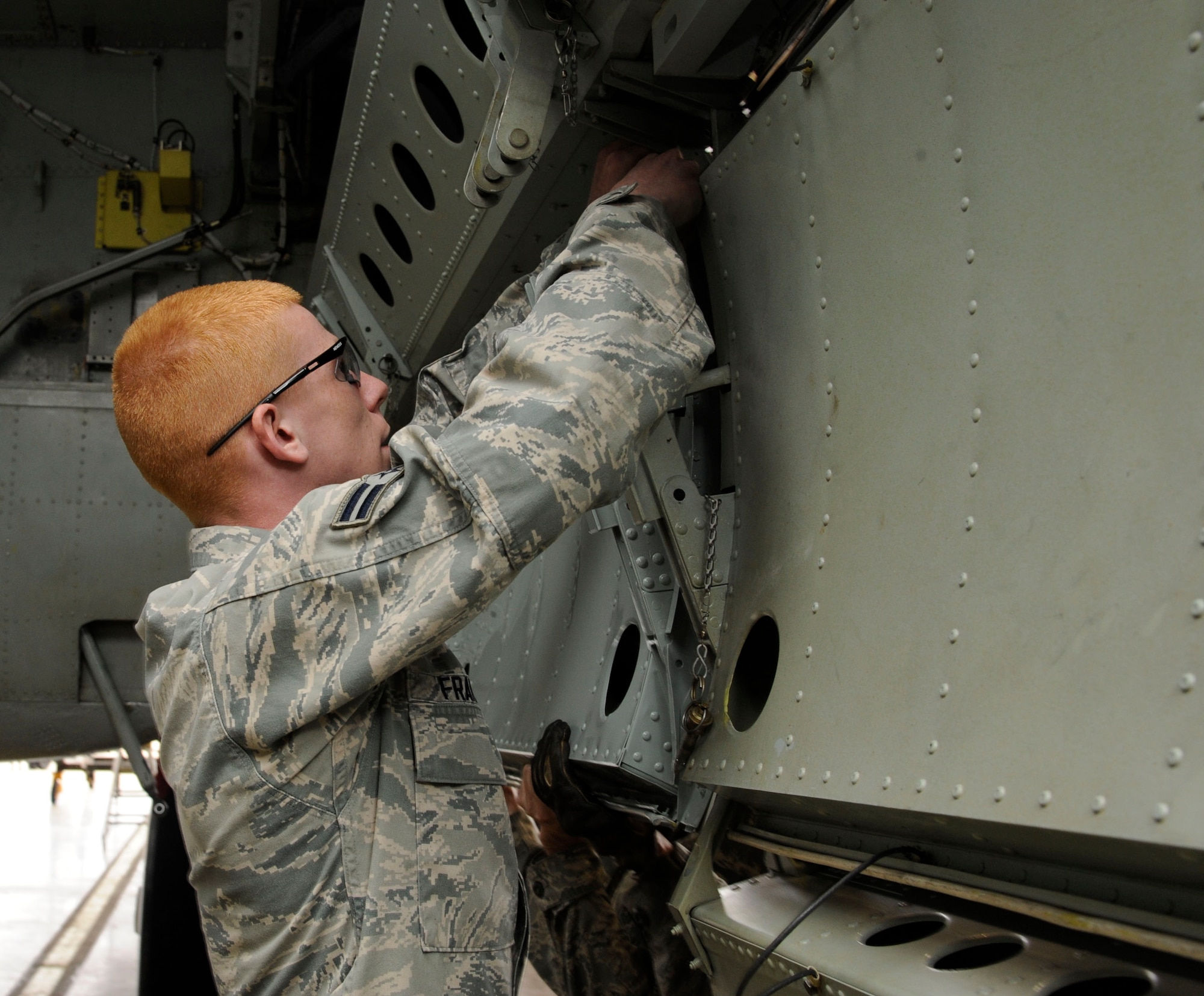 Airman 1st Class William Franks, 2nd Maintenance Squadron crew chief, installs a bomb bay door on a B-52H Stratofortress during a phase inspection on Barksdale Air Force Base, La., April 26, 2013. Aircraft come in for phase inspections every 450 flight hours. The inspections also include repairs to the aircraft's systems, such as the engines, electrical and life support systems, and hydraulics. (U.S. Air Force photo/Airman 1st Class Andrew Moua)