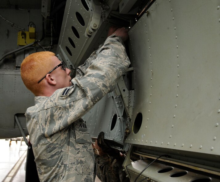 Airman 1st Class William Franks, 2nd Maintenance Squadron crew chief, installs a bomb bay door on a B-52H Stratofortress during a phase inspection on Barksdale Air Force Base, La., April 26, 2013. Aircraft come in for phase inspections every 450 flight hours. The inspections also include repairs to the aircraft's systems, such as the engines, electrical and life support systems, and hydraulics. (U.S. Air Force photo/Airman 1st Class Andrew Moua)