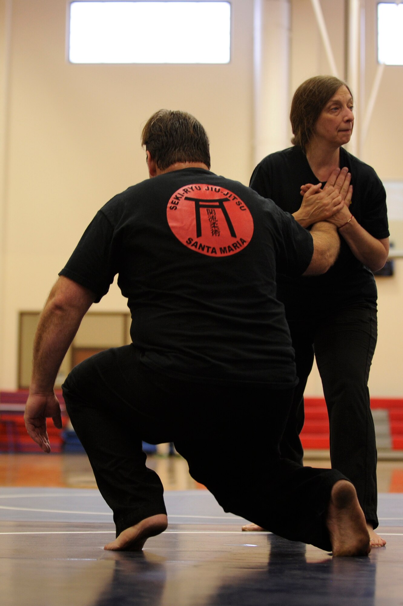VANDENBERG AIR FORCE BASE, Calif. – Valerie Anne Pellar, a Seki-Ryu Jiu-Jitsu 2nd degree black belt, demonstrates a wrist lock maneuver to Team V members during an annual self-defense course at the base gym here Thursday, April 25, 2013. Seki-Ryu Jiu-Jitsu is a real world self-defense training that includes escapes, joint locks, blocks, throws, strikes, kicks, submissions, and weapon defense techniques. (U.S. Air Force photo/Senior Airman Lael Huss)