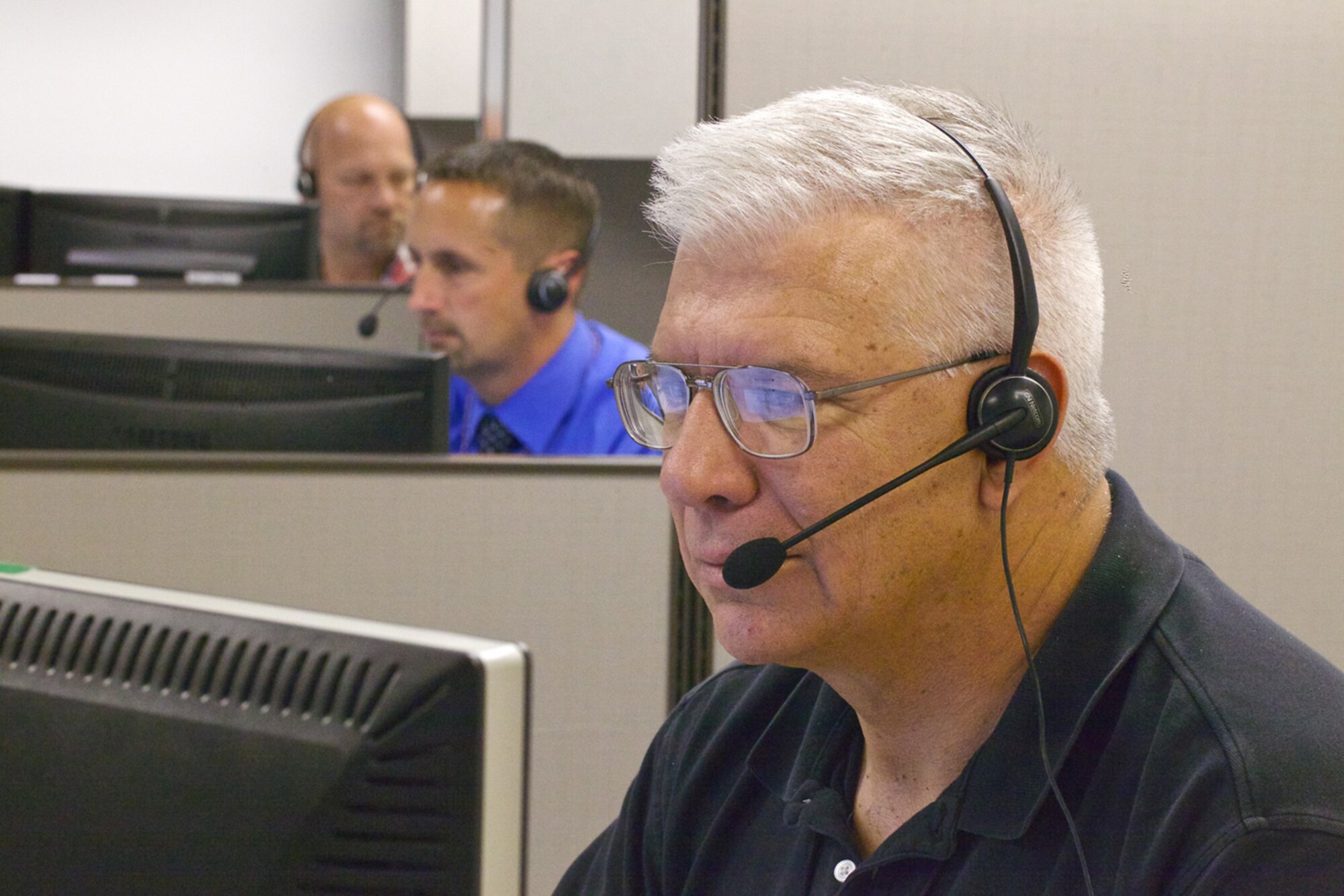 TYNDALL AIR FORCE BASE, Fla. -- AFCEC Reach-Back Center Agent Alan Wackowski researches an answer to a caller’s question here on April 24, 2013. Since 2005, the RBC has handled more than 50,000 requests for information. Agents field questions from deployed locations, the Pentagon, major commands, bases, industry, and other services. The RBC also supports AFCEC’s experts by maintaining a vast database of civil engineer information that they can quickly reference in response to customers’ queries. (U.S. Air Force photo/Eddie Green)