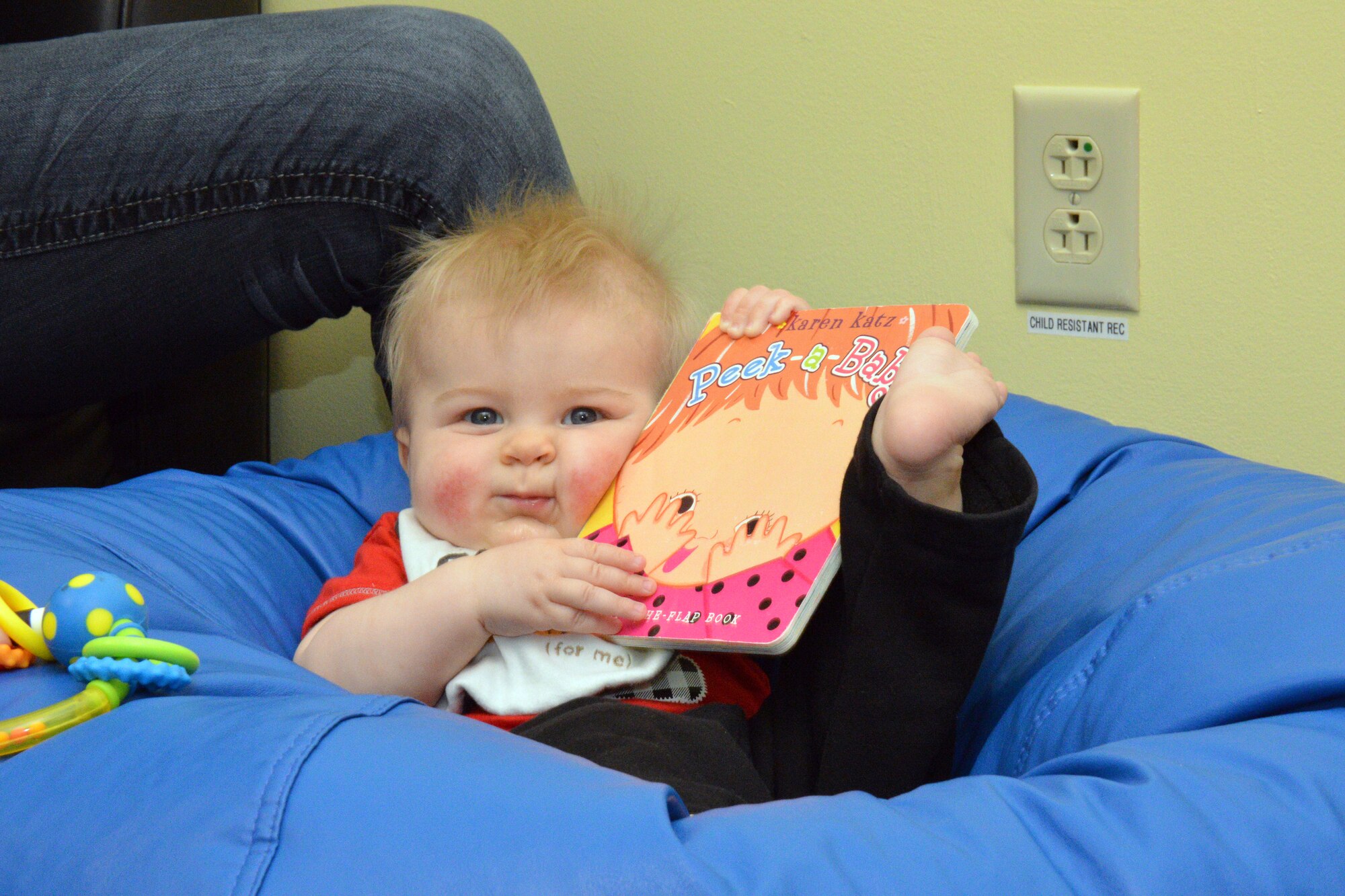 The Reach Out and Read program at Robins received a nod this month following a visit from representatives with the Governor’s Office for Children and Families. Six-month-old Ezra Gangi, kicks up his heel after receiving his new book. (U.S. Air Force photo by Ed Aspera)