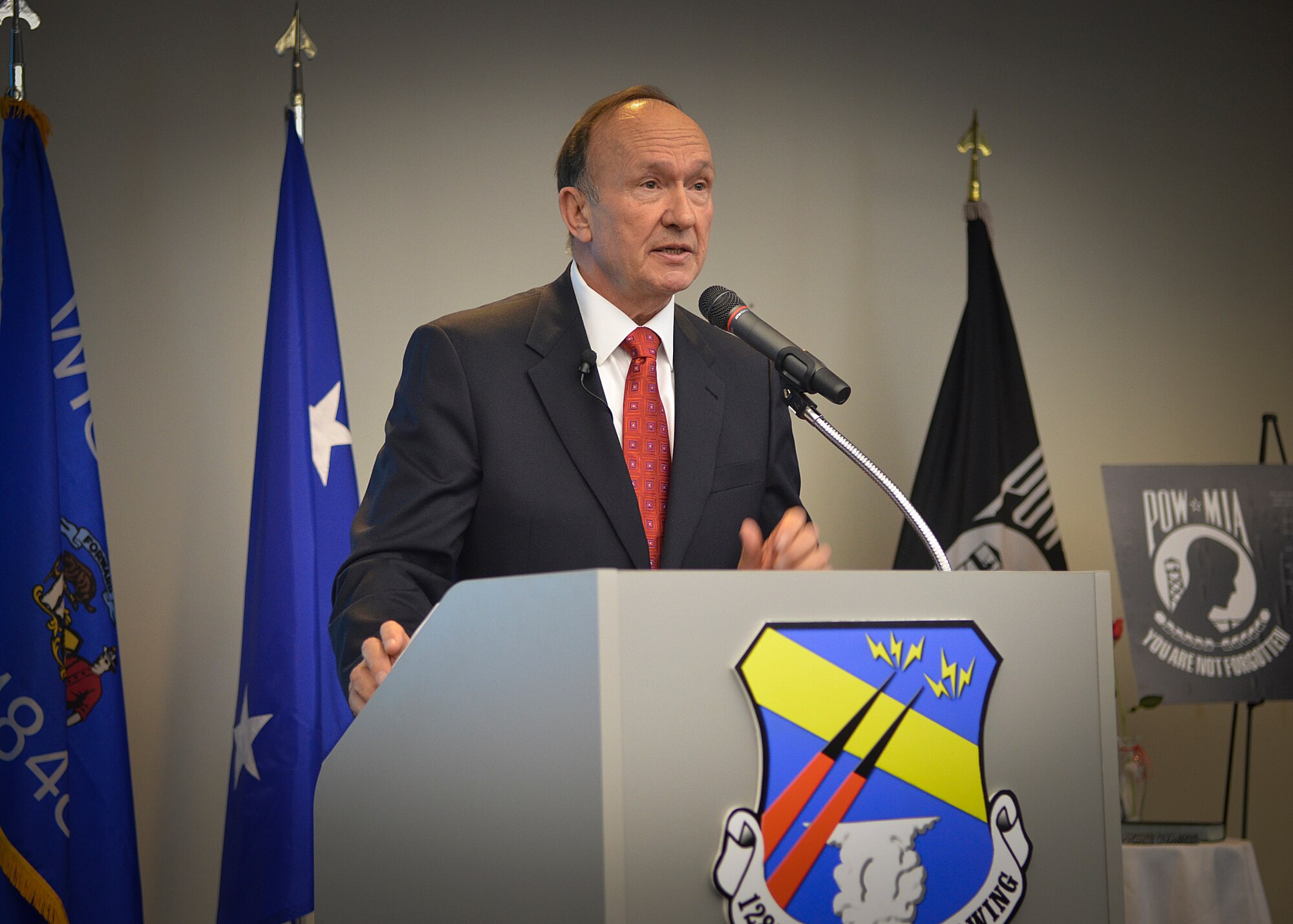 Retired Air Force Captain Guy Gruters speaks to the Airmen of the 128th Air Refueling Wing in Milwaukee, Thurs., April 25, 2013, about his time as a prisoner of war during the Vietnam War. 
Gruters, a fighter pilot, was shot down twice over enemy territory and spent more than five years in an enemy prison camp.  (U.S. Air National Guard photo by Senior Master Sgt. Jeffrey Rohloff/Released)