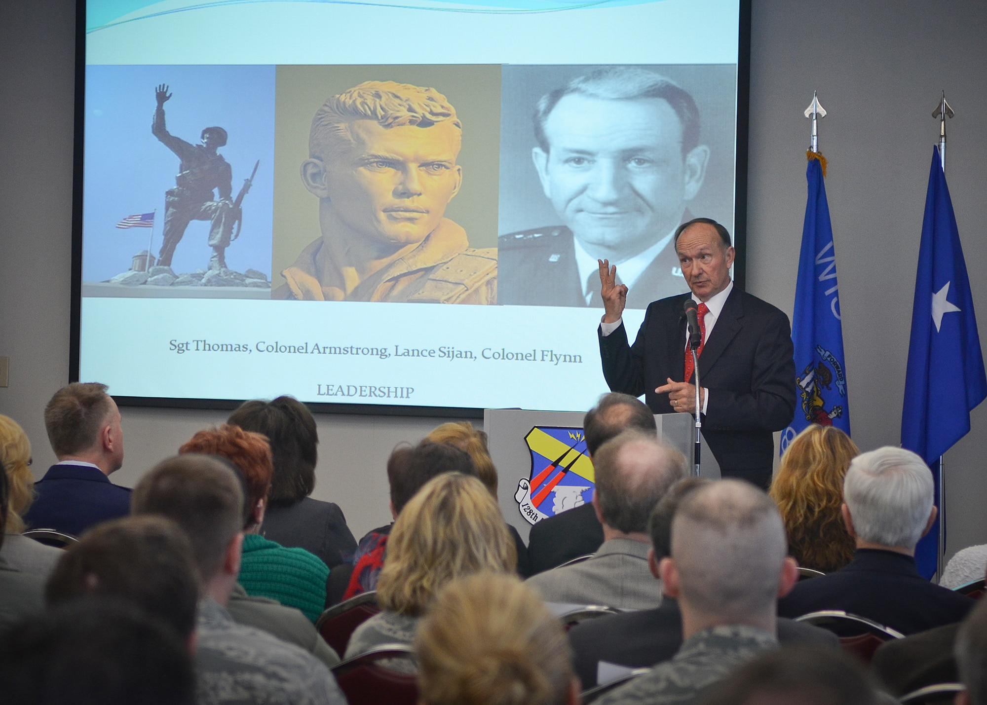 Retired Air Force Captain Guy Gruters speaks to the Airmen of the 128th Air Refueling Wing in Milwaukee, Thurs., April 25, 2013, about his time as a prisoner of war during the Vietnam War. 
Gruters, a fighter pilot, was shot down twice over enemy territory and spent more than five years in an enemy prison camp.  (U.S. Air National Guard photo by Senior Master Sgt. Jeffrey Rohloff/Released)