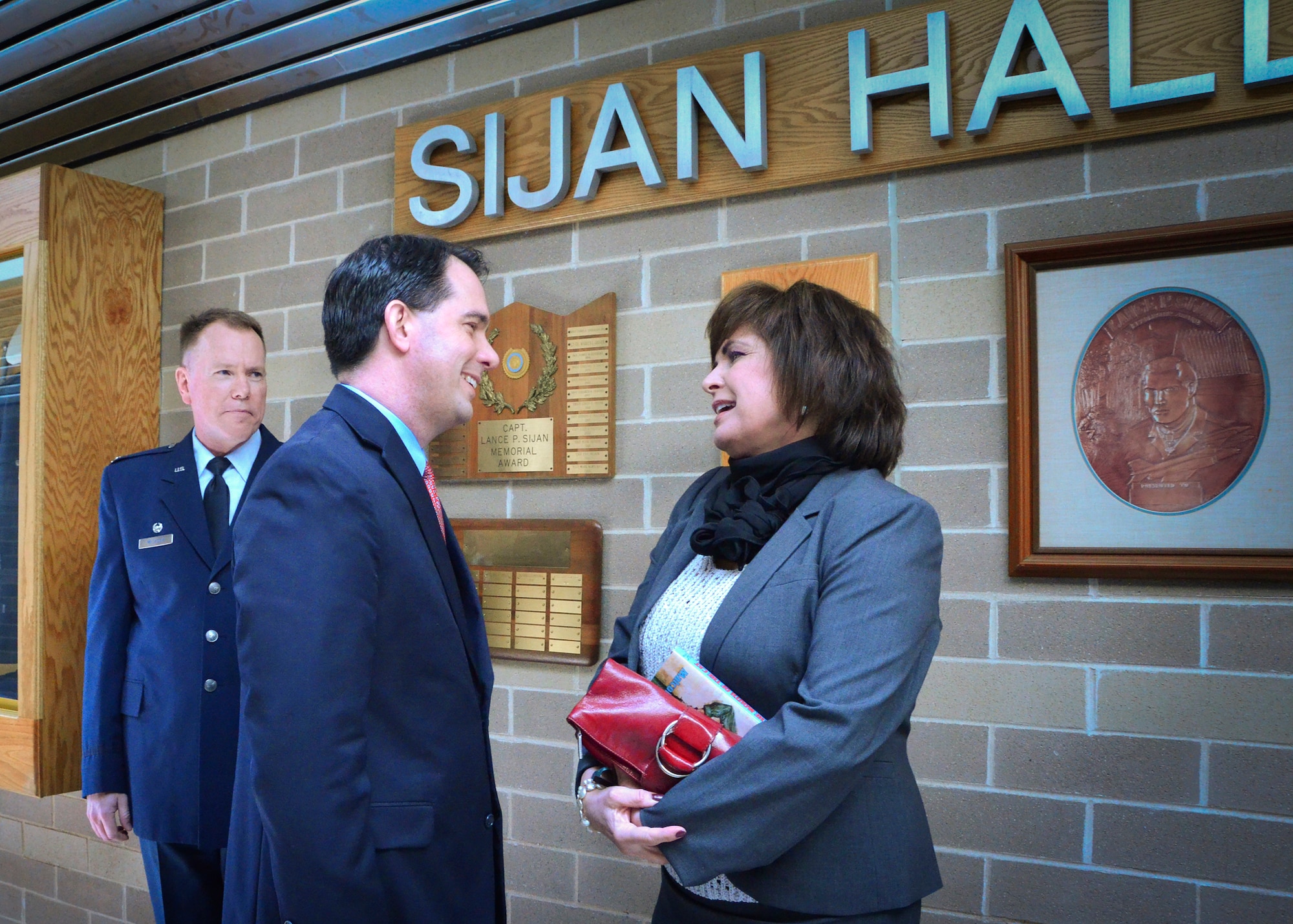 Janine Sijan Rozina greets Wisconsin Governor Scott Walker in Sijan Hall at Milwaukee’s 128th Air Refueling Wing Thurs., April 25 2013 as 128th Wing Commander, Col. Ted Metzgar, looks on.
Walker and Sijan, sister of Air Force Medal of Honor recipient Capt. Lance Sijan, were at the Air National Guard base to listen to a presentation by Vietnam War Prisoner of War, Capt. Guy Gruters.  (U.S. Air National Guard photo by 1st Lt. Nathan Wallin/Released)