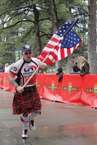 Senior Master Sgt. Tim Gill, 419th Operations Group, approaches the finish line of the Salt Lake City Marathon at Liberty Park April 20. Gill ran the race with a U.S. flag in honor of the Boston Marathon victims. (Courtesy photo)