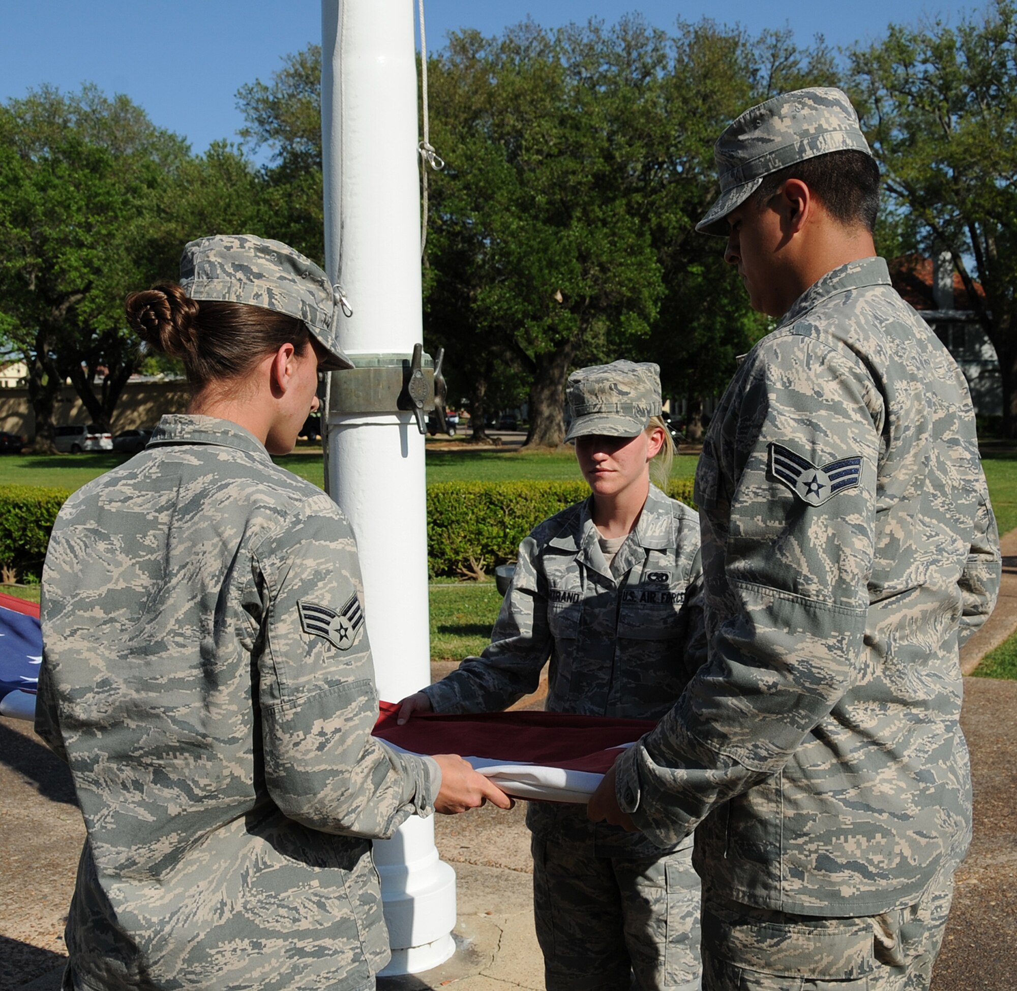 Airman Leadership School class 13-4 students fold the American Flag during retreat on Barksdale Air Force Base, La., April 25, 2013. The retreat ceremony serves a two-fold purpose- it signals the end of the official duty day and pays respect to the flag. (U.S. Air Force photo/Airman 1st Class Benjamin Gonsier)
