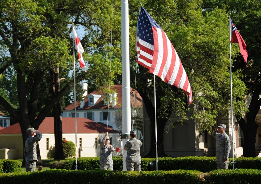 Airman Leadership School class 13-4 students lower the American Flag during retreat on Barksdale Air Force Base, La., April 25, 2013. The flag detail consists of two halyards to lower the flag and two Airmen to salute and grab the flag before it touches the ground. (U.S. Air Force photo/Airman 1st Class Benjamin Gonsier)
