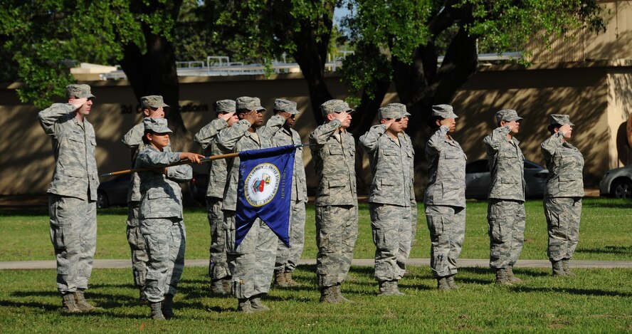 Airman Leadership School class 13-4 students salute the American Flag during retreat on Barksdale Air Force Base, La., April 25, 2013. The retreat ceremony serves a two-fold purpose- it signals the end of the official duty day and pays respect to the flag. (U.S. Air Force photo/Airman 1st Class Benjamin Gonsier)