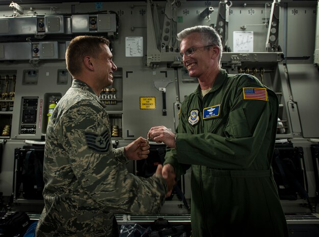 Gen. Paul Selva, Air Mobility Command commander, hands the keys to a new C-17 Globemaster III to Tech. Sgt. Gary Pongetti, 437th Aircraft Maintenance Squadron crew chief April 25, 2013, at Joint Base Charleston – Air Base, S.C. Joint Base Charleston is scheduled to receive two additional C-17s this year, as Boeing completes work on the Air Force’s final Globemasters. The first C-17 to enter the Air Force’s inventory arrived at Charleston Air Force Base in June 1993. The C-17 is capable of rapid strategic delivery of troops and all types of cargo to main operating bases or directly to forward bases in the deployment area. (U.S. Air Force photo/ Senior Airman Dennis Sloan)