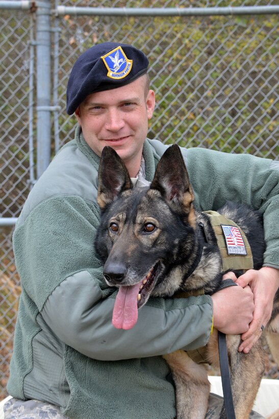 Senior Airman Ian, Bailey, 78th Security Forces Squadron Military Working Dog  trainer, and his MWD, Soyer, share a quiet moment for a photo shoot, prior to training. (U.S. Air Force photo by Ed Aspera)