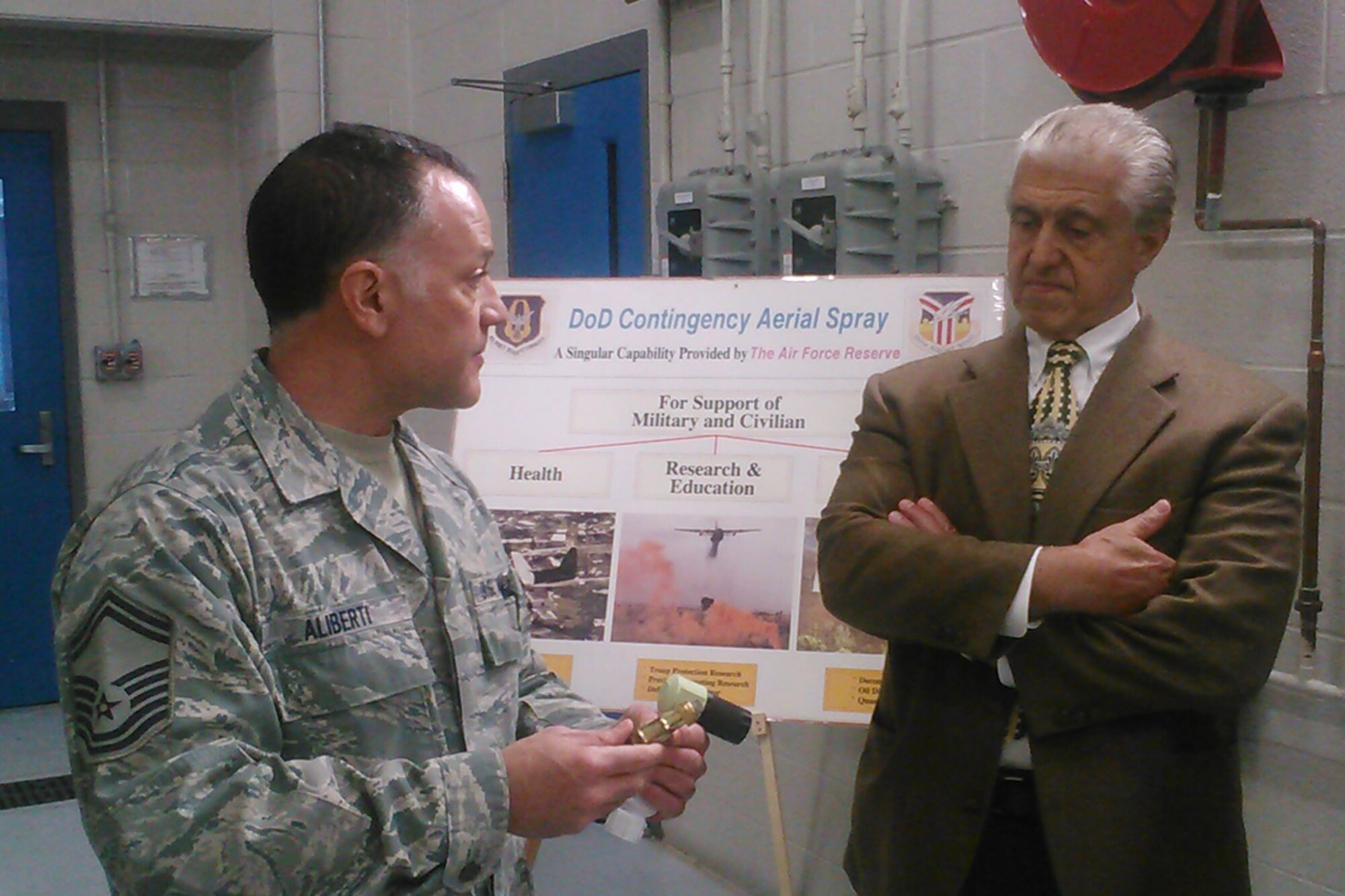 YOUNGSTOWN AIR RESERVE STATION, Ohio -- Air Force Reserve Senior Master Sgt. Phil Aliberti, chief of the 910th Aerial Spray Maintenance Flight, shows aerial spray nozzles to Chuck Sammarone, the mayor of Youngstown, at a hangar here, April 26, 2013. The mayor was visiting the installation at the invitation of 910th Airlift Wing commander, Col. James Dignan as part of the commander’s outreach to civic leaders in surrounding communities. The 910th is the home of the Department of Defense’s only aerial spray capability. U.S. Air Force photo by Master Sgt. Bob Barko Jr.