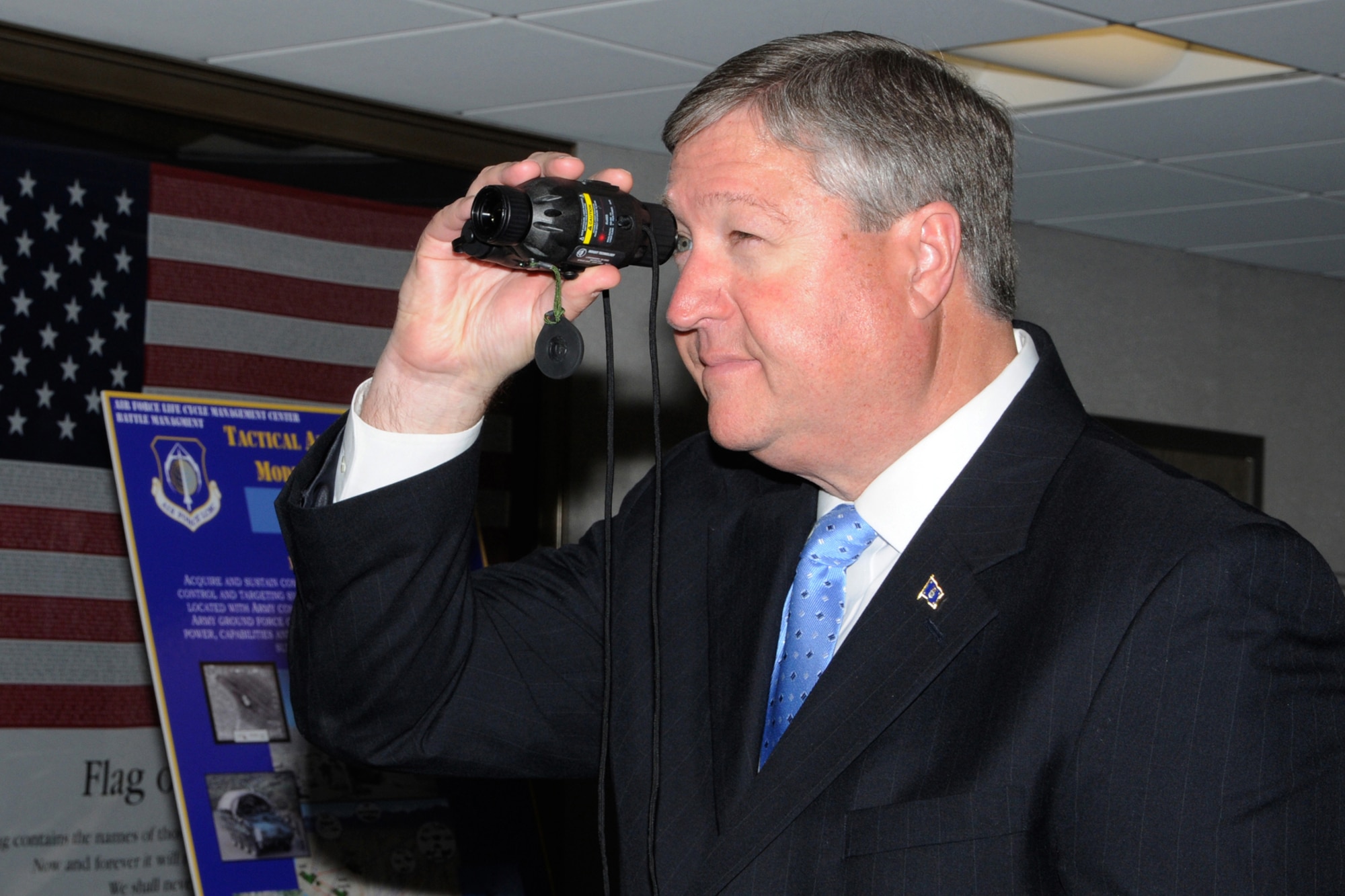 HANSCOM AIR FORCE BASE, Mass. -- Secretary of the Air Force Michael Donley checks out the Mini-Thermal Monocular device acquired by program managers here and used by Air Force Tactical Air Control Party members to view thermal imagery and mark targets during his visit here April 25. During his visit, the secretary also met with military and civilian award winners and held an Airman's call with base personnel, thanking Hanscom members for their contributions to providing innovative technology to Airmen around the world. (U.S. Air Force Photo by Linda LaBonte Britt)