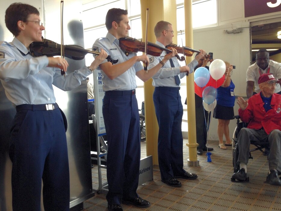 Members of the Air Force Strings greet Honor Flight members at National
Airport
