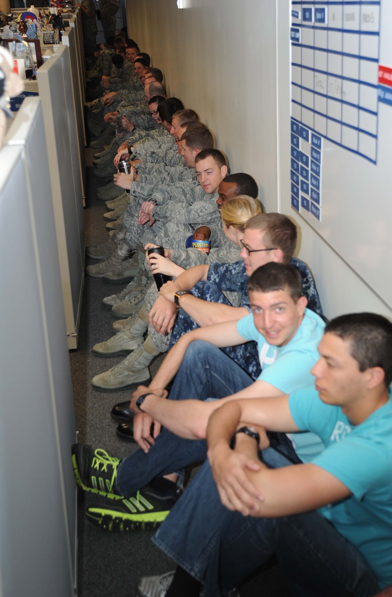 Airmen seek shelter inside an instructor bay at the weather complex for a tornado warning during a hurricane exercise April 24, 2013, at Keesler Air Force Base, Miss.  Throughout the exercise, “Hurricane Hana” brought severe thunderstorms, F2 tornado strength winds, rain and hail damage to several base facilities.  The purpose of the exercise was to prepare Keesler for the upcoming hurricane season.  (U.S. Air Force photo by Kemberly Groue)
