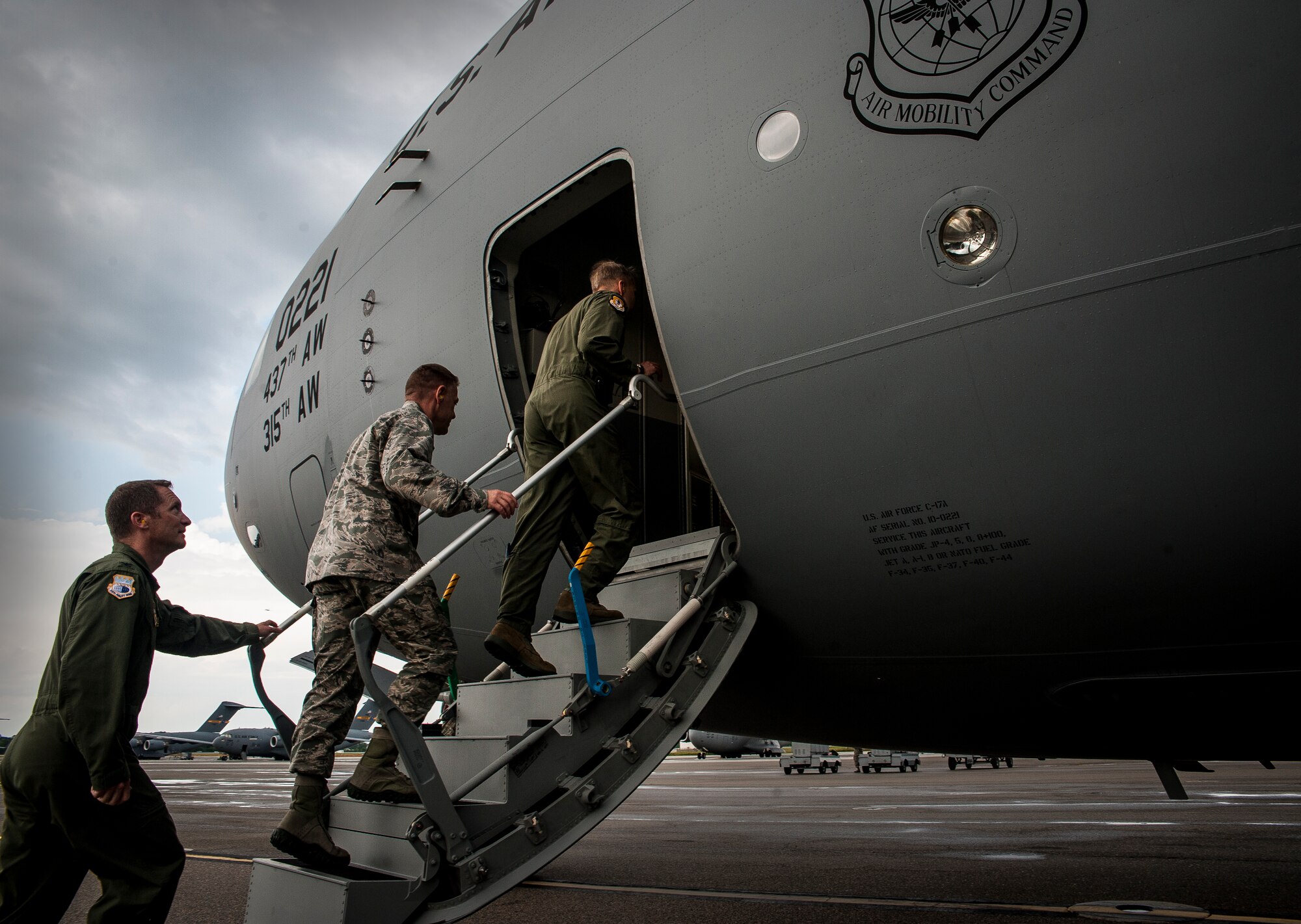Col. Darren Hartford, 437th Airlift Wing commander, Col. Richard McComb, Joint Base Charleston commander, and Col. James Fontanella, 315th Airlift Wing commander, board a brand new C-17 Globemaster III flown by Gen. Paul Selva, Air Mobility Command commander April 25, 2013, at Joint Base Charleston, S.C. Joint Base Charleston is scheduled to receive two additional C-17s this year, as Boeing completes work on the Air Force’s final Globemasters.   The first C-17 to enter the Air Force’s inventory arrived at Charleston Air Force Base in June 1993.. The C-17 is capable of rapid strategic delivery of troops and all types of cargo to main operating bases or directly to forward bases in the deployment area. (U.S. Air Force photo/ Senior Airman Dennis Sloan)