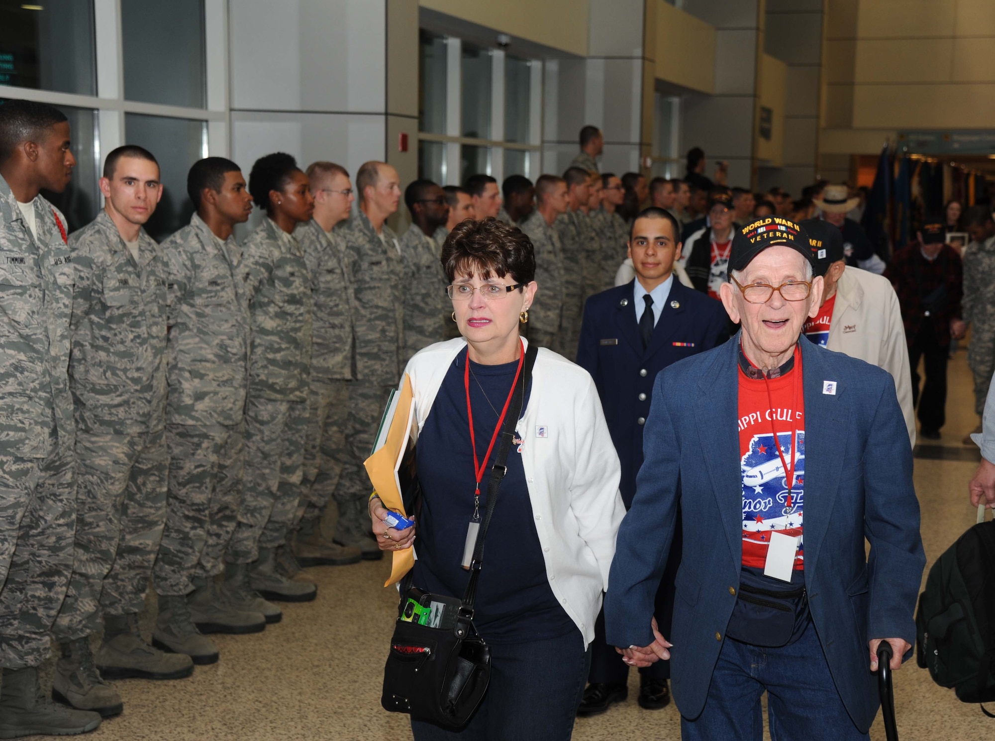 Airmen line the hallway to honor the veterans as Norma Parker and her father, Everett Murphy, World War II veteran, are escorted by Airman Basic Zachary Abraham, 336th Training Squadron, at the fifth Mississippi Gulf Coast Honor Flight to Washington, D.C., April 23, 2013, at the Gulfport/Biloxi International Airport.  The Honor Flight program honors our nation’s World War II veterans by sending them on a one-day visit to various monuments in Washington, D.C.  (U.S. Air Force photo by Kemberly Groue)
