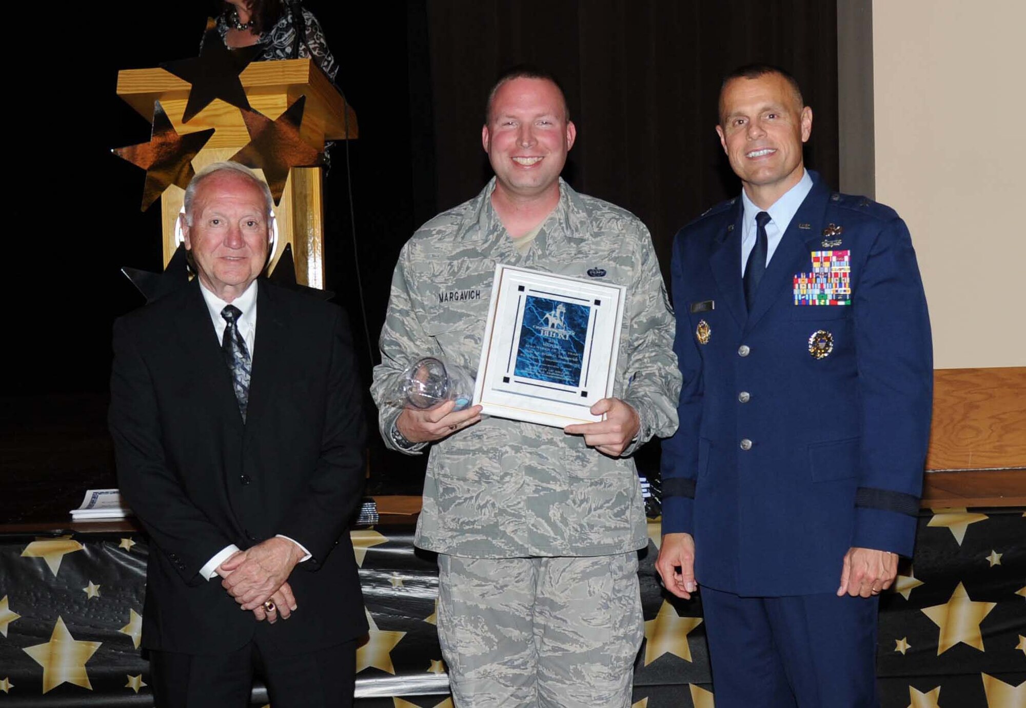 A.J. Holloway, Mayor of Biloxi, and Brig. Gen. Brad Spacy, 81st Training Wing commander, take a photo with Tech. Sgt. Brian Margavich, 333rd Training Squadron, Keesler Air Force Base, at Biloxi’s 30th Annual Volunteer Recognition Awards Ceremony April 23, 2013, at Biloxi, Miss.  He was named Biloxi’s Military Individual Volunteer of the Year.  (U.S. Air Force photo by Kemberly Groue)