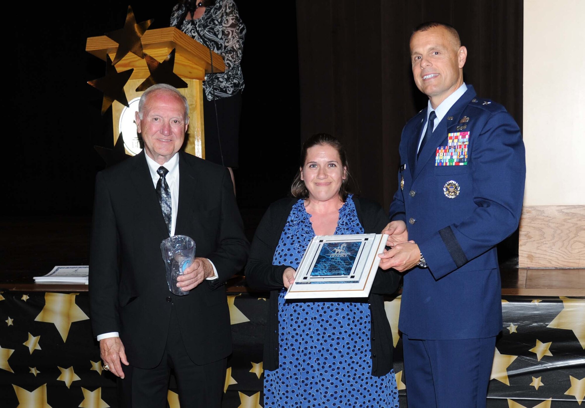 A.J. Holloway, Mayor of Biloxi, and Brig. Gen. Brad Spacy, 81st Training Wing commander, take a photo with Jennifer Ferguson, wife of Master Sgt. Stephen Ferguson, 333rd Training Squadron, Keesler Air Force Base, at Biloxi’s 30th Annual Volunteer Recognition Awards Ceremony April 23, 2013, at Biloxi, Miss. She was named Biloxi’s Health Volunteer of the Year.  (U.S. Air Force photo by Kemberly Groue)