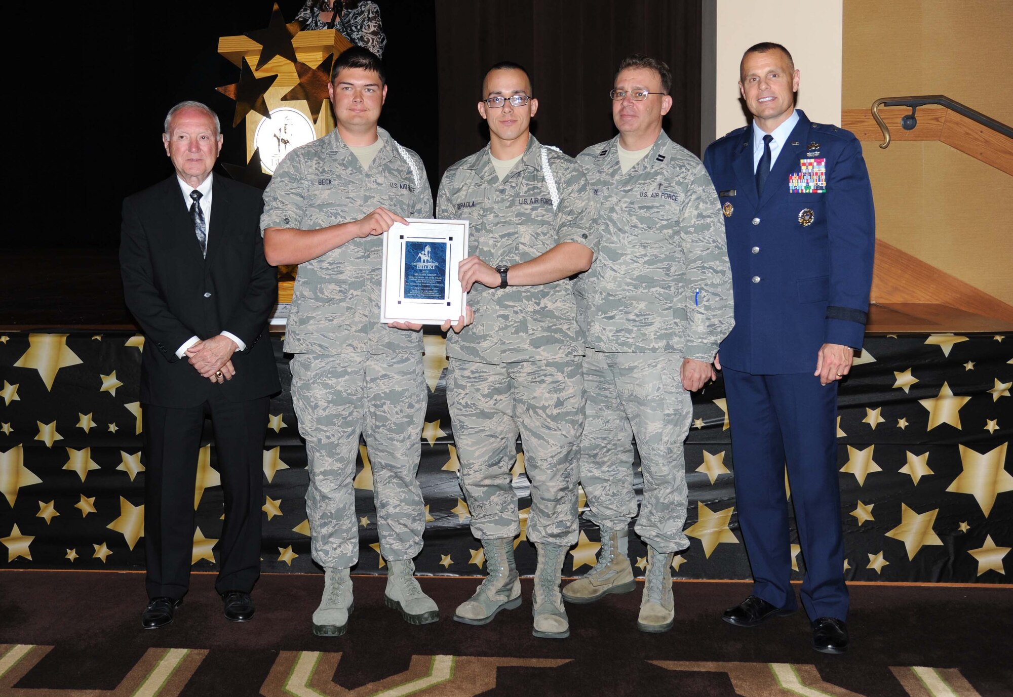 A.J. Holloway, Mayor of Biloxi, and Brig. Gen. Brad Spacy, 81st Training Wing commander, take a photo with Airmen Basic Shane Beck, 336th Training Squadron and Alec DePaola, 338th TRS, and Chaplain (Capt.) John Schuetze, 81st Training Wing, Keesler Air Force Base, at Biloxi’s 30th Annual Volunteer Recognition Awards Ceremony April 23, 2013, at Biloxi, Miss.  The Fishbowl Student Ministry Center White Rope Program was named Biloxi’s Military Group Volunteer of the Year.  (U.S. Air Force photo by Kemberly Groue)
