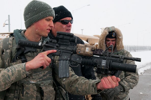 Senior Airman Jeremy Duhancik, 90th Security Forces Squadron, answers questions about his M4 rifle and the attached M203 grenade launcher from a Defense Threat Reduction Agency inspector April 12 as part of a Defense Nuclear Surety Inspection. The 90th Missile Wing completed a Nuclear Surety Inspection and a Nuclear Operations Readiness Inspection conducted by the Air Force Global Strike Command Inspector General at the same time as the DNSI. (U.S. Air Force photo by R.J. Oriez)