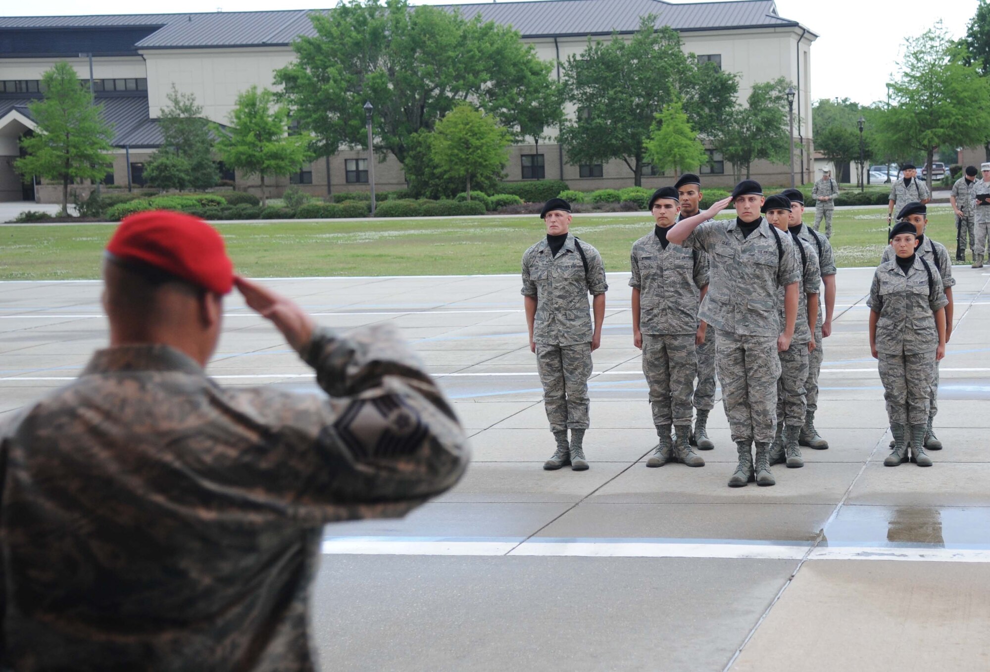 Senior Master Sgt. Bradley Reilly, 334th Training Squadron combat control instructor, renders a salute to the 338th Training Squadron drill team as they enter the field of regulation during the 81st Training Group drill down performance April 24, 2013, at Keesler Air Force Base, Miss.  Reilly served as the reviewing official for the event.  (U.S. Air Force photo by Kemberly Groue)