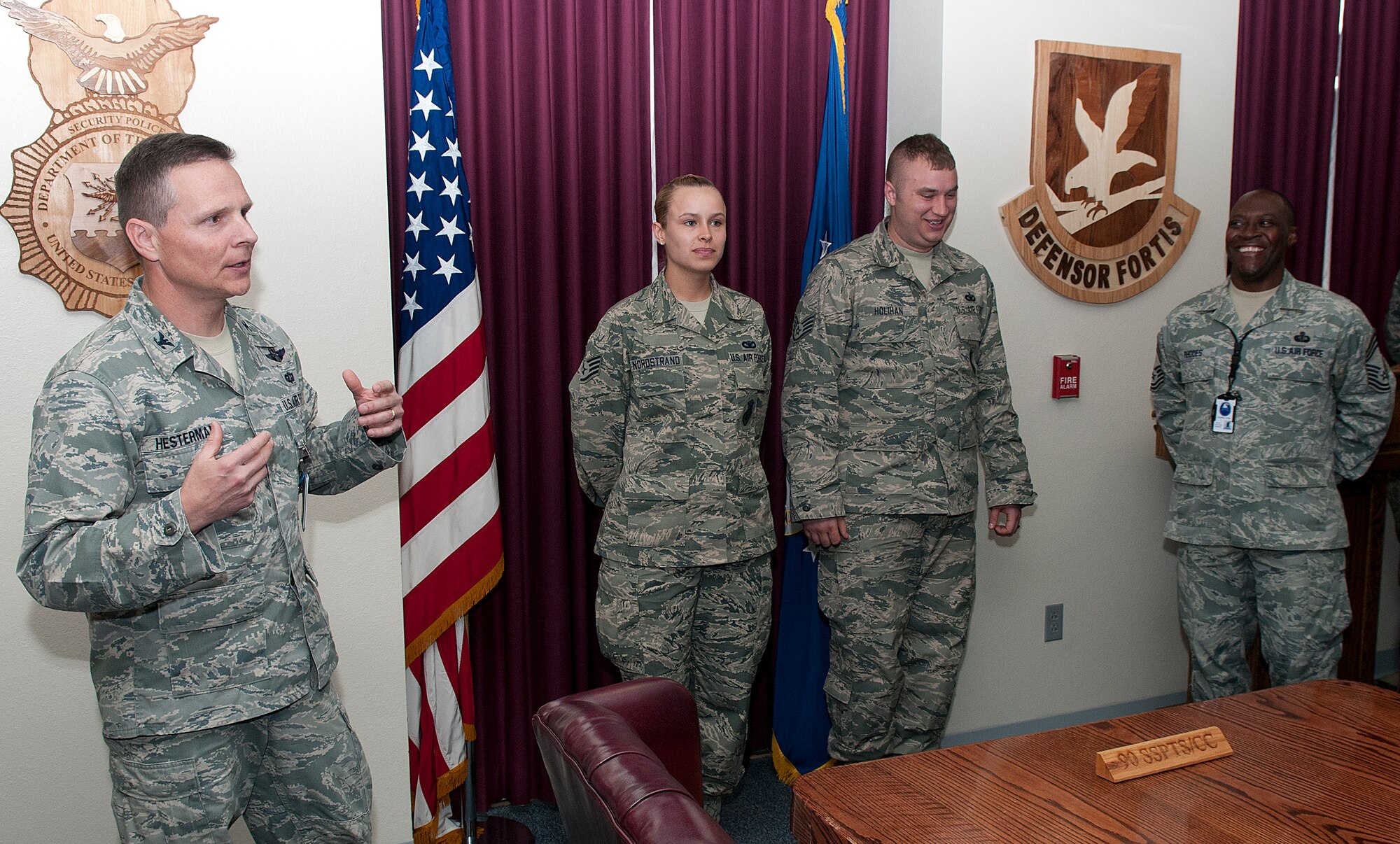 Col. Thomas Hesterman, Air Force Global Strike Command inspector general, singles out Staff Sgt. Stephanie Nordstrand and Tech. Sgt. Casey Holihan, 90th Security Forces Group, April 15, for their performance during a nuclear surety inspection. (U.S. Air Force photo by R.J. Oriez)
