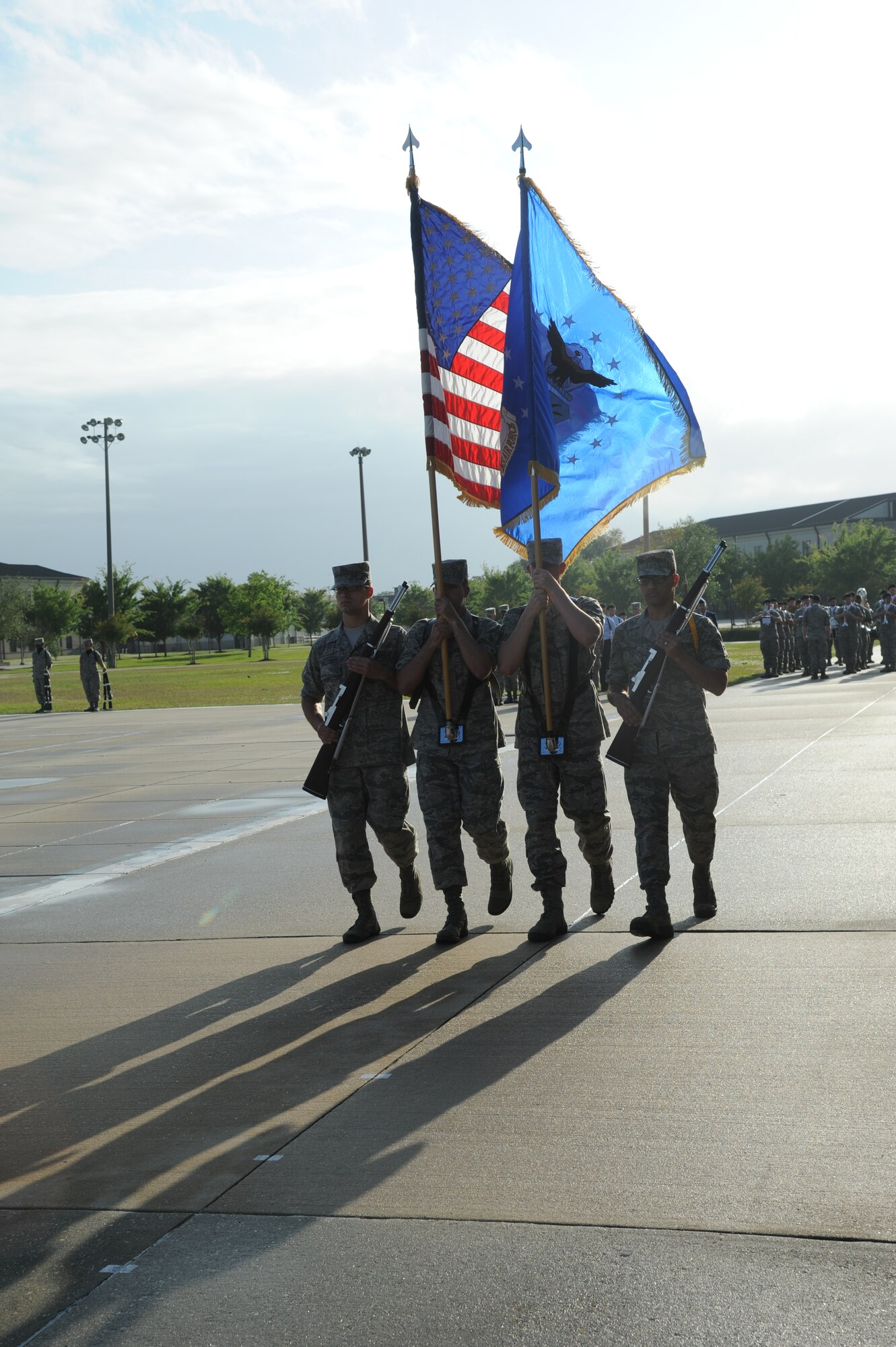 The Keesler Honor Guard carries the flags onto the drill pad for the singing of the National Anthem during the 81st Training Group drill down performance April 24, 2013, at Keesler Air Force Base, Miss.  The 335th Training Squadron made a clean sweep in the competition, winning first place in every category to include open ranks, regulation, freestyle and overall.  (U.S. Air Force photo by Kemberly Groue)