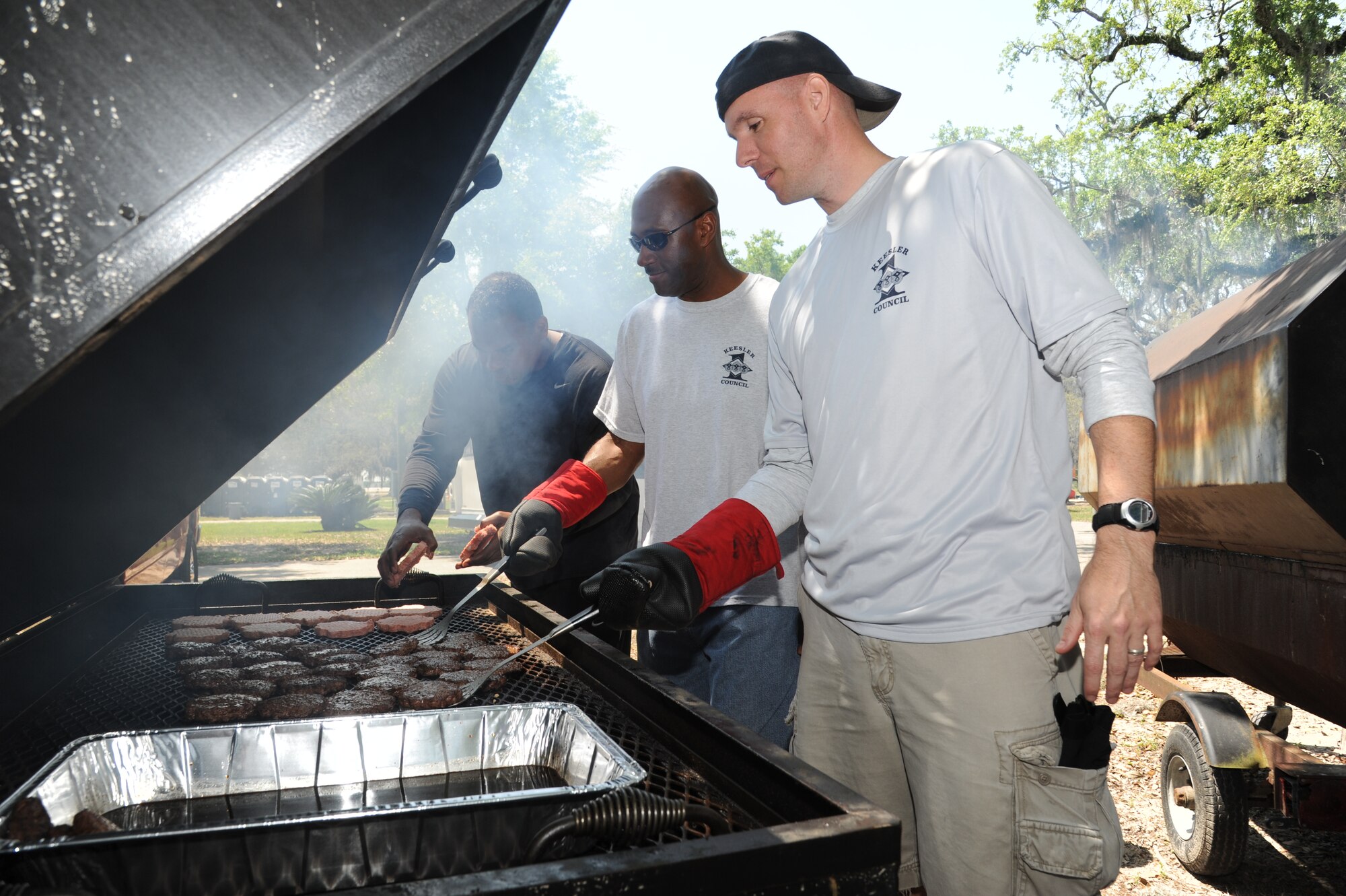 Master Sgt. Chris Henry, 81st Communications Squadron; Senior Master Sgt. Kevin Holmes, 338th Training Squadron; and Master Sgt. Jeffrey Moody, 81st Comptroller Squadron, along with other first sergeants grill hamburgers and hot dogs during the Commander-in-Chief’s Installation Excellence award base picnic at the Marina park April 25, 2013, Keesler Air Force Base, Miss.  The event consisted of free food and beverages, music, games and an awards presentation.  (U.S. Air Force photo by Kemberly Groue)