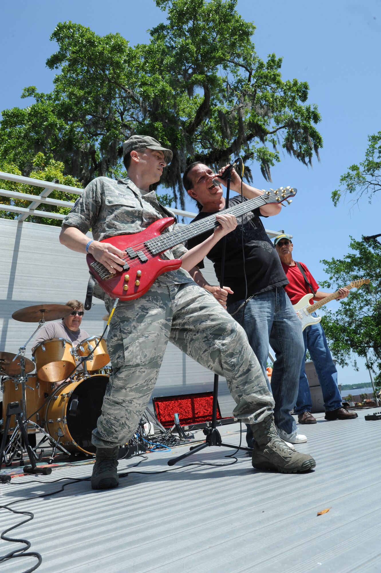 Master Sgt. Paul Opp, 333rd Training Squadron, plays bass with The Music Station band’s lead singer, Dave Gibson, during the Commander-in-Chief’s Installation Excellence award base picnic at the Marina park April 25, 2013, Keesler Air Force Base, Miss.  The event consisted of free food and beverages, music, games and an awards presentation.  (U.S. Air Force photo by Kemberly Groue)