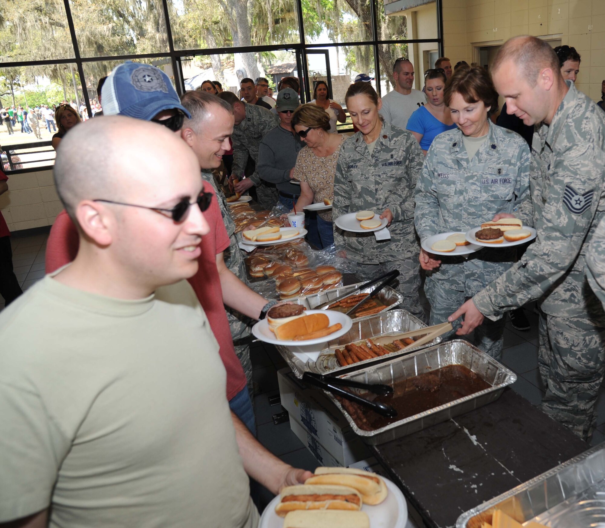 Staff Sgt. James Providenti, 336th Training Squadron, helps himself to the free food and beverages at the Commander-in-Chief’s Installation Excellence award base picnic at the Marina park April 25, 2013, Keesler Air Force Base, Miss.  The event also consisted of music, games and an awards presentation.  (U.S. Air Force photo by Kemberly Groue)