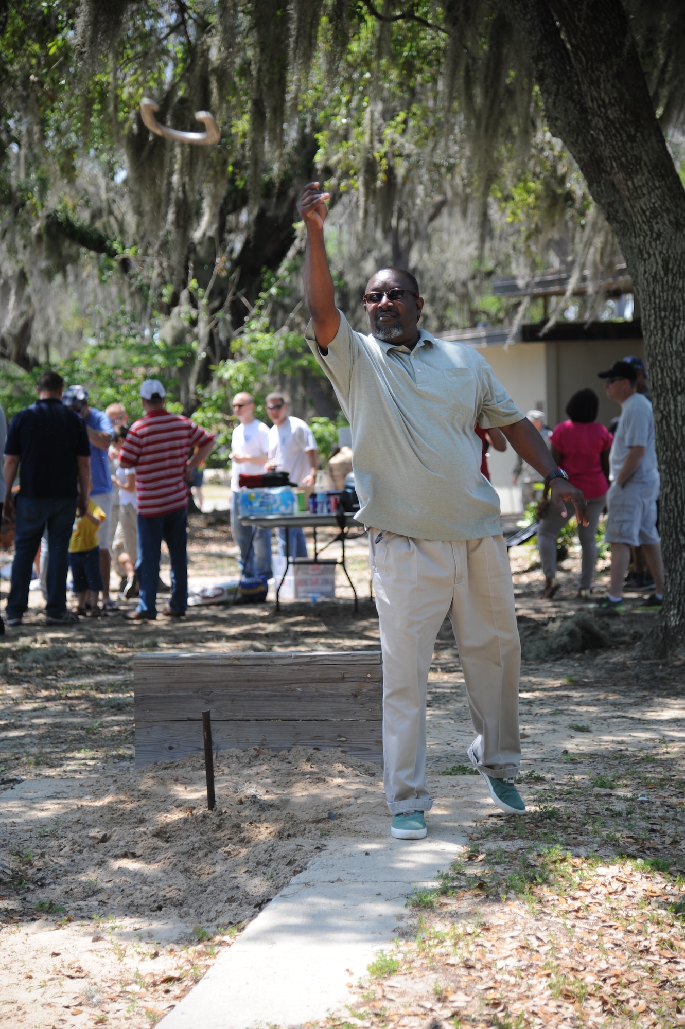 Billy Bell, 81st Comptroller Squadron, plays a game of horseshoes during the Commander-in-Chief’s Installation Excellence award base picnic at the Marina park April 25, 2013, Keesler Air Force Base, Miss.  The event consisted of free food and beverages, music, games and an awards presentation.  (U.S. Air Force photo by Kemberly Groue)
