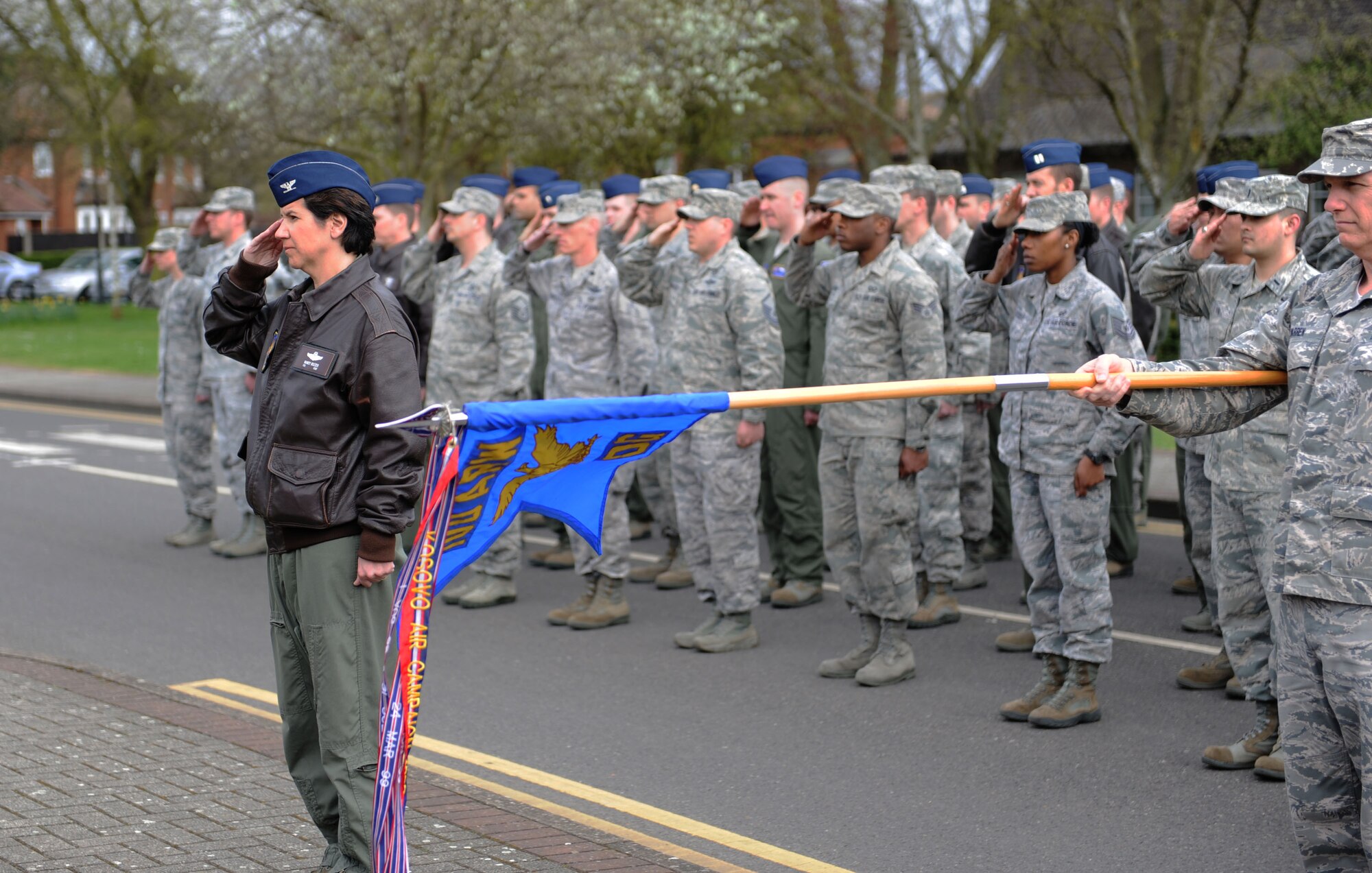 Col. Nancy Bozzer, 100th Operations Group commander, salutes the U.S. flag during a monthly retreat ceremony April 26, 2013, on RAF Mildenhall, England. Retreat is a long-standing tradition honoring the flag and signaling the end of the duty day. (U.S. Air Force photo by Airman 1st Class Preston Webb/Released)