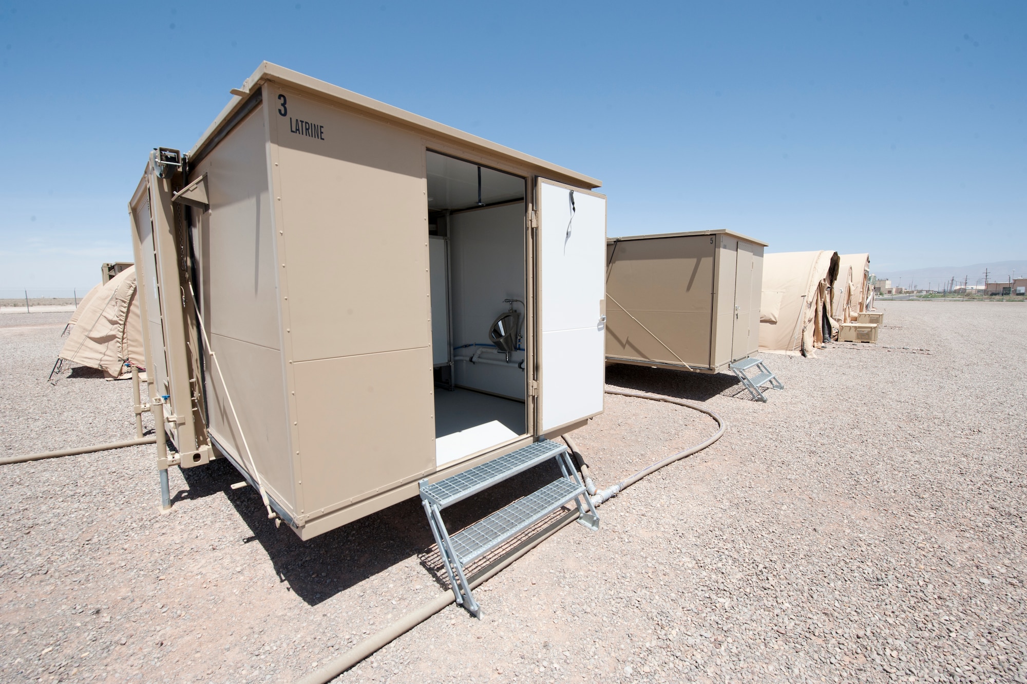 A new hygiene system is fully assembled and tested at Holloman Air Force Base, N.M., April 24. The 49th Materiel Maintenance Squadron was the first unit to receive and test the new hygiene system, complete with latrines and showers, which will eventually be utilized in forward deployed locations. The new hygiene system provides a cleaner, more private, and more durable alternative to the old systems. (U.S. Air Force photo by Airman 1st Class Daniel E. Liddicoet)