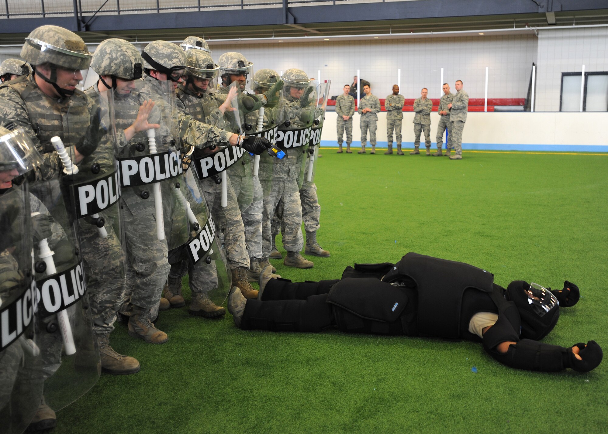 Members of the 319th Security Forces Squadron conduct riot squad training on April 9, 2013, at Grand Forks Air Force Base, N.D.  A riot squad is designed to safely infiltrate crowds while using the least amount of force required subduing rioters and making arrests when necessary. (U.S. Air Force photo/Airman 1st Class Xavier Navarro)