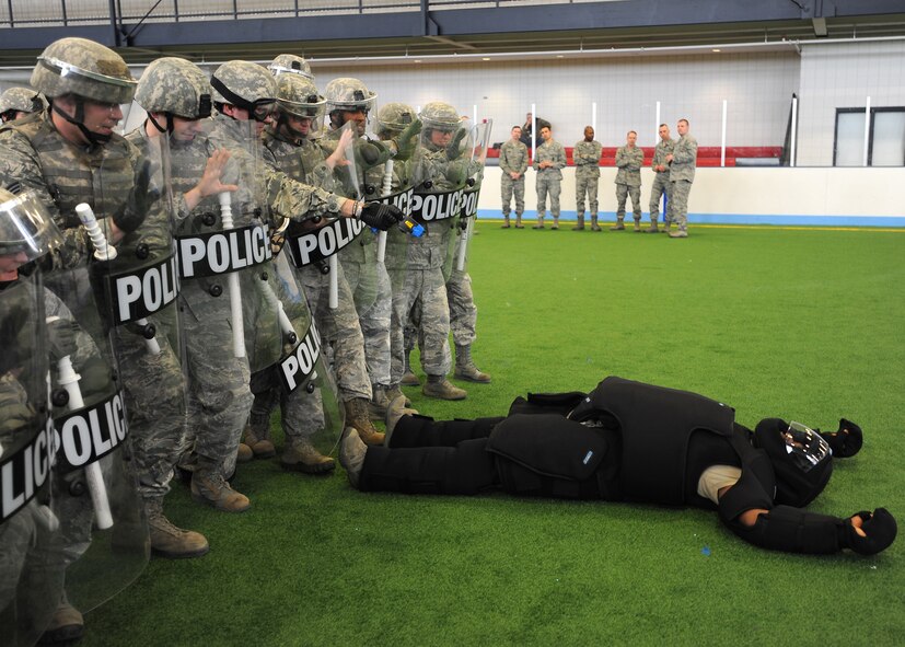 Members of the 319th Security Forces Squadron conduct riot squad training April 9, 2013, at Grand Forks Air Force Base, N.D. A riot squad is designed to safely infiltrate crowds while using the least amount of force required subduing rioters and making arrests when necessary. (U.S. Air Force photo/Airman 1st Class Xavier Navarro) 

